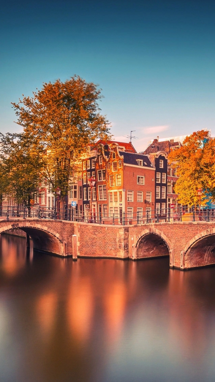 Brown Concrete Bridge Over River During Daytime. Wallpaper in 750x1334 Resolution
