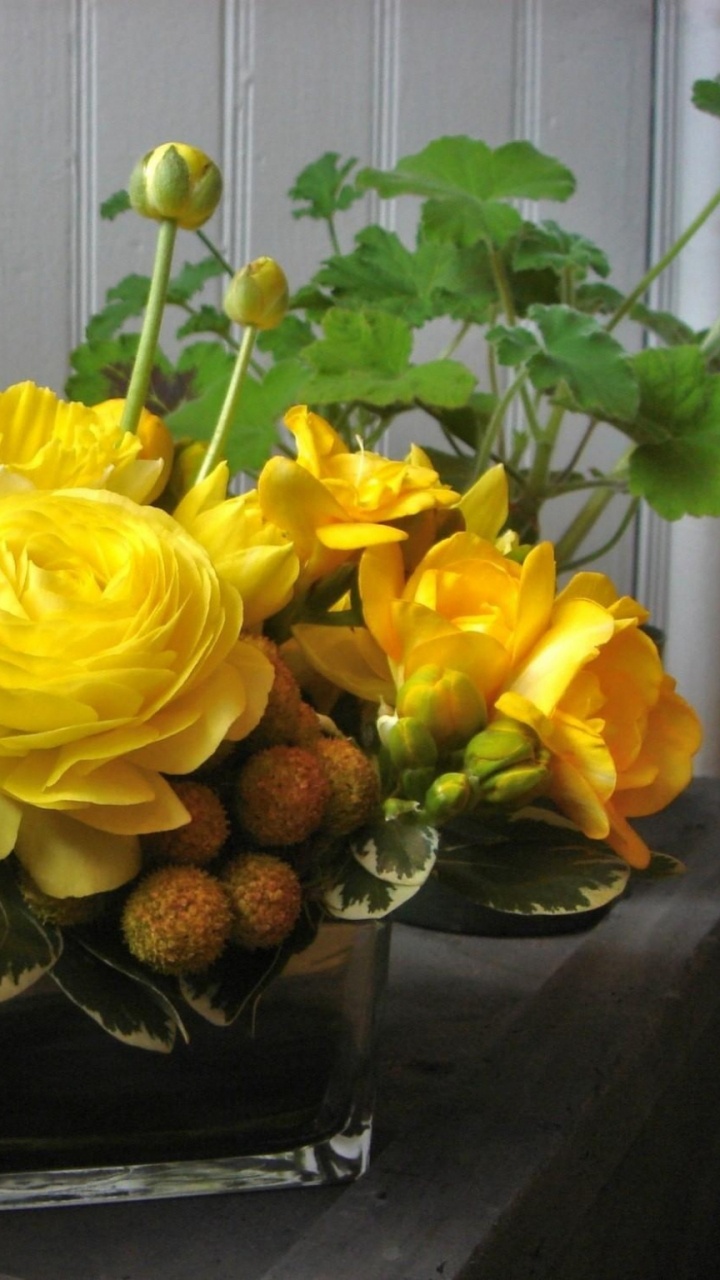 Yellow Flowers on Black Plastic Container. Wallpaper in 720x1280 Resolution