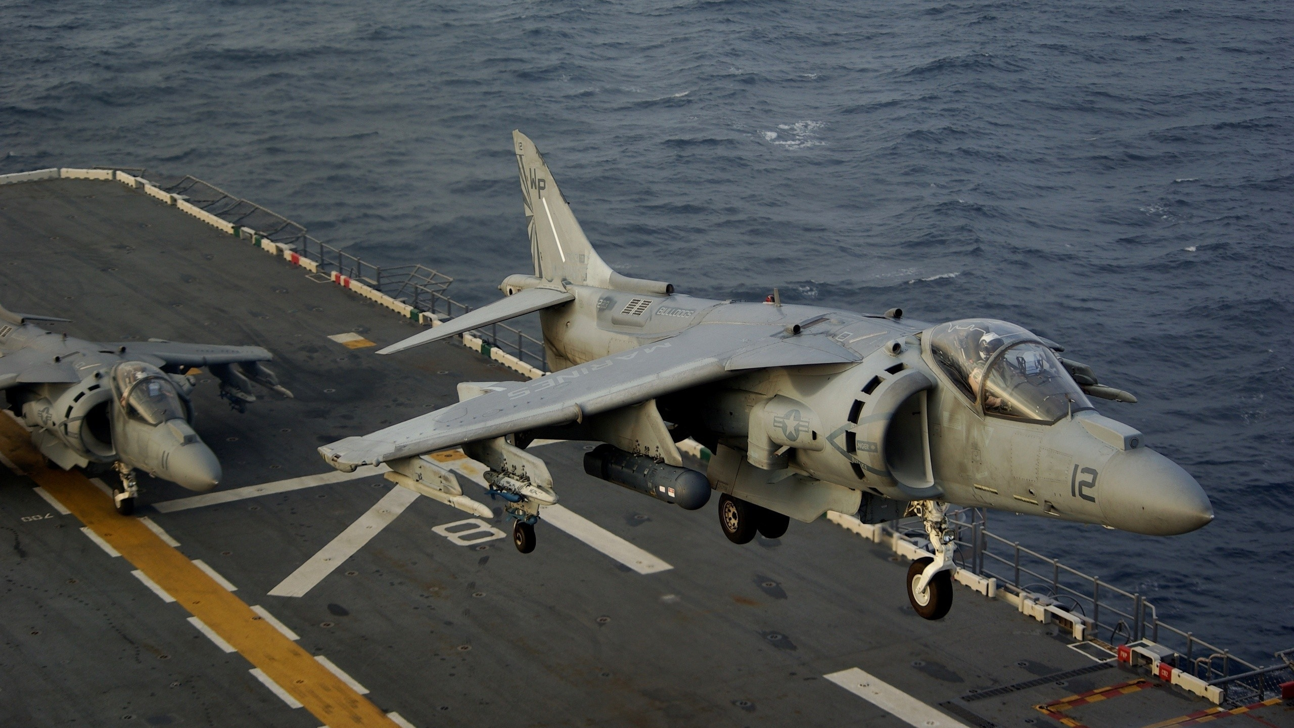 Gray Fighter Plane on Dock During Daytime. Wallpaper in 2560x1440 Resolution