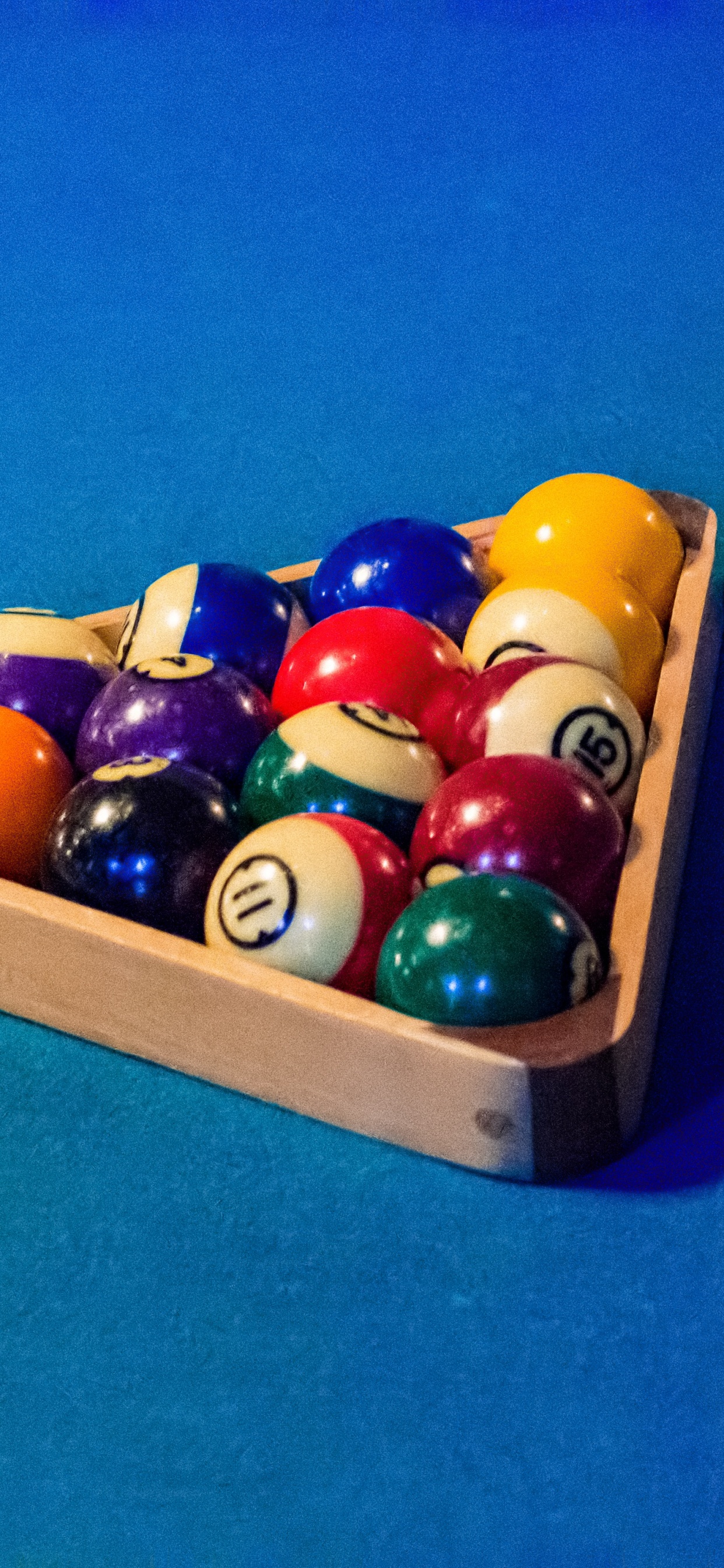 Billiard Balls on Blue Table. Wallpaper in 1242x2688 Resolution