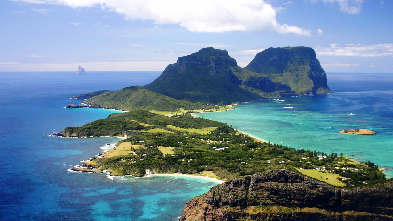 Green and Brown Mountain Beside Blue Sea Under Blue Sky During Daytime. Wallpaper in 1366x768 Resolution
