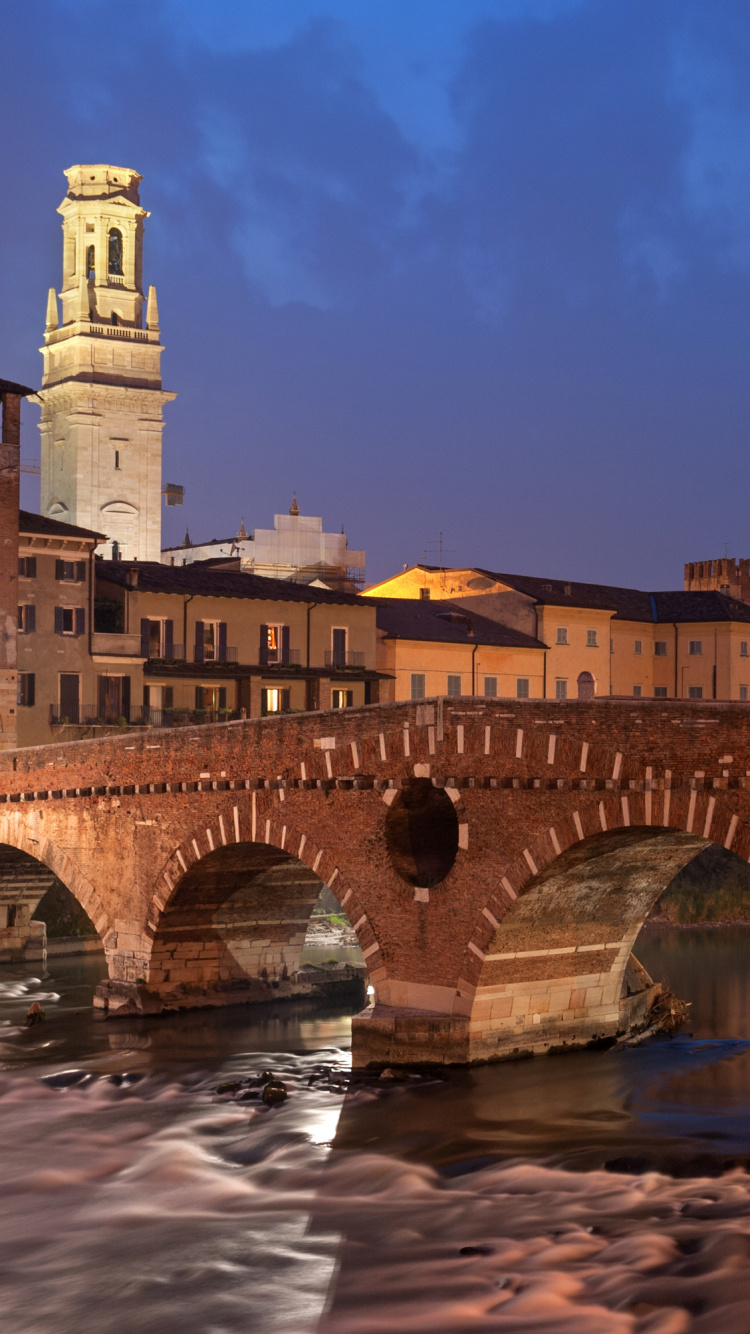 Brown Concrete Bridge Over River During Night Time. Wallpaper in 750x1334 Resolution