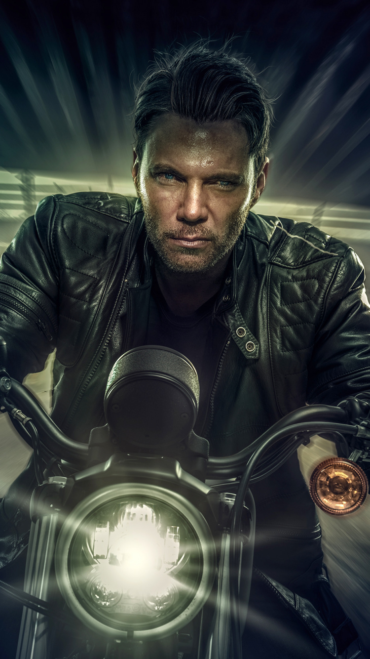 Man in Black Leather Jacket Riding Motorcycle. Wallpaper in 750x1334 Resolution