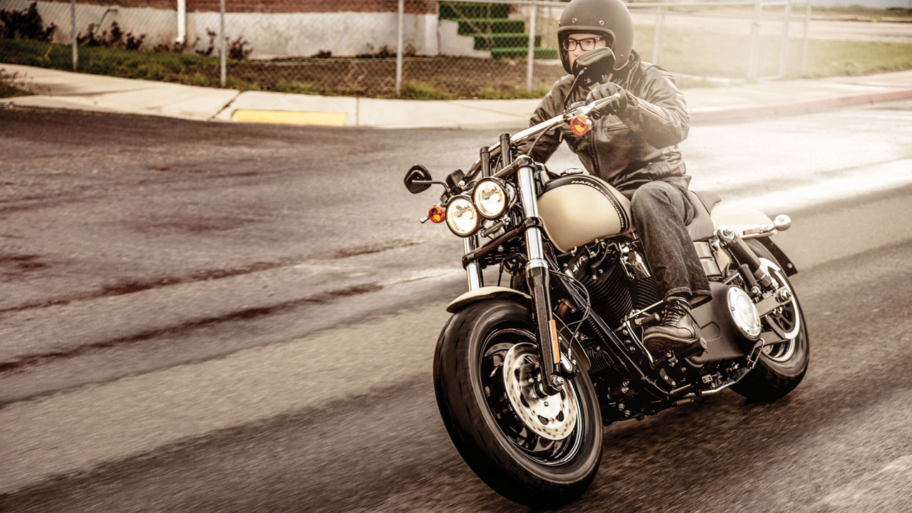 Man in Black Jacket Riding on Black Cruiser Motorcycle. Wallpaper in 1280x720 Resolution
