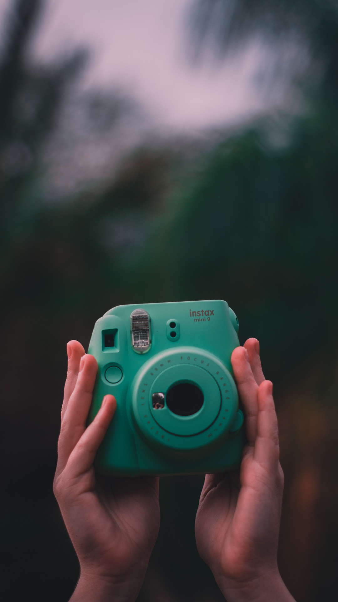 Person Holding Green Point and Shoot Camera. Wallpaper in 1080x1920 Resolution