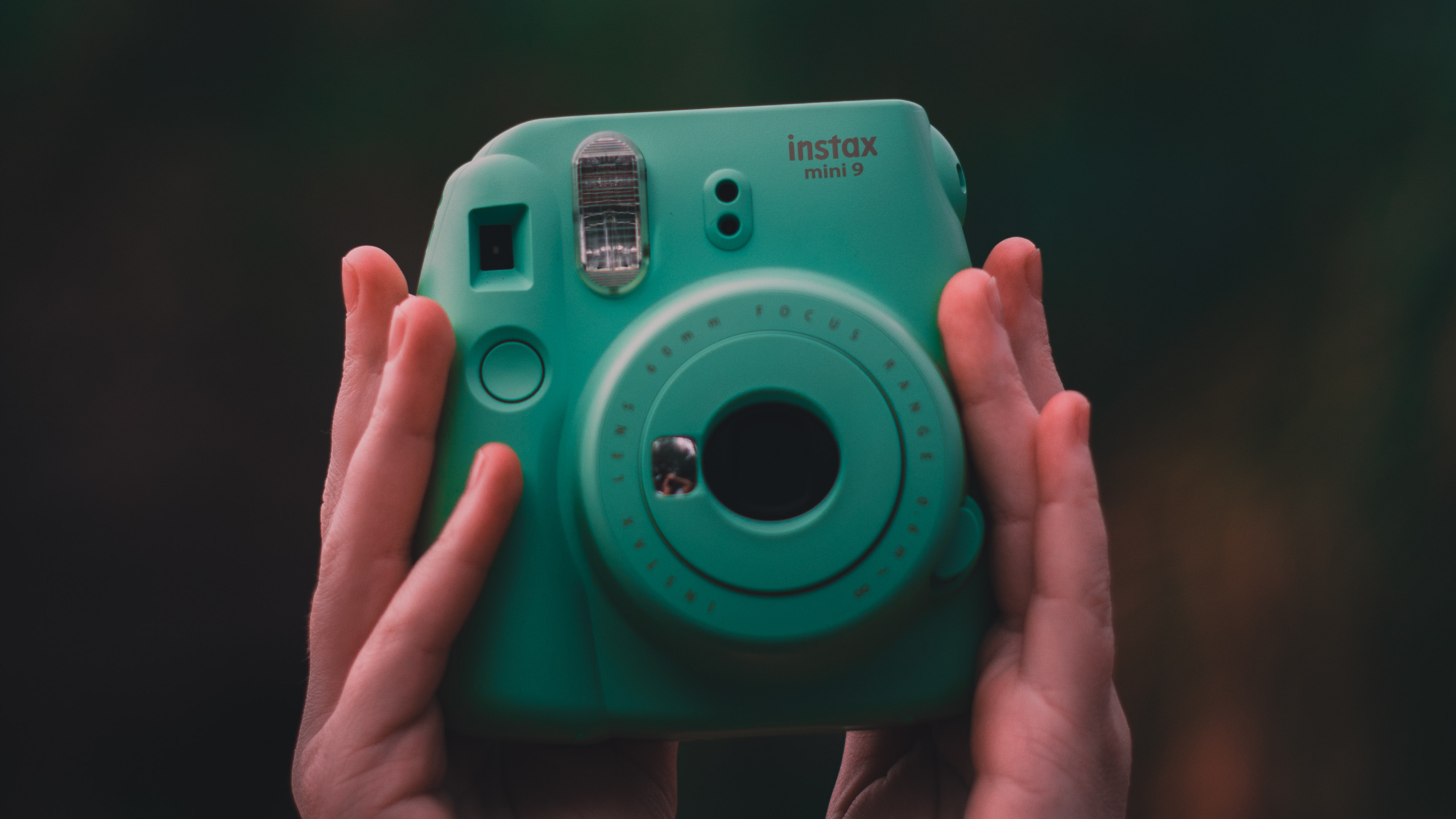 Person Holding Green Point and Shoot Camera. Wallpaper in 2560x1440 Resolution