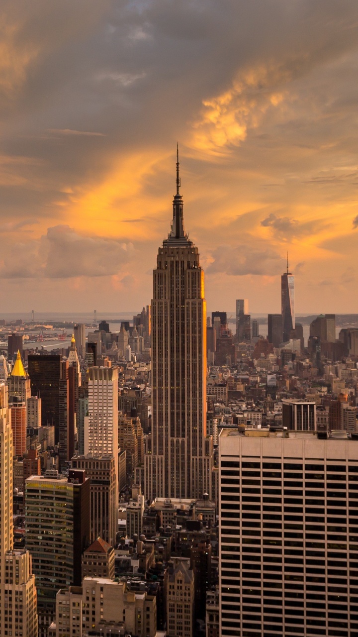 City Skyline Under Cloudy Sky During Sunset. Wallpaper in 720x1280 Resolution