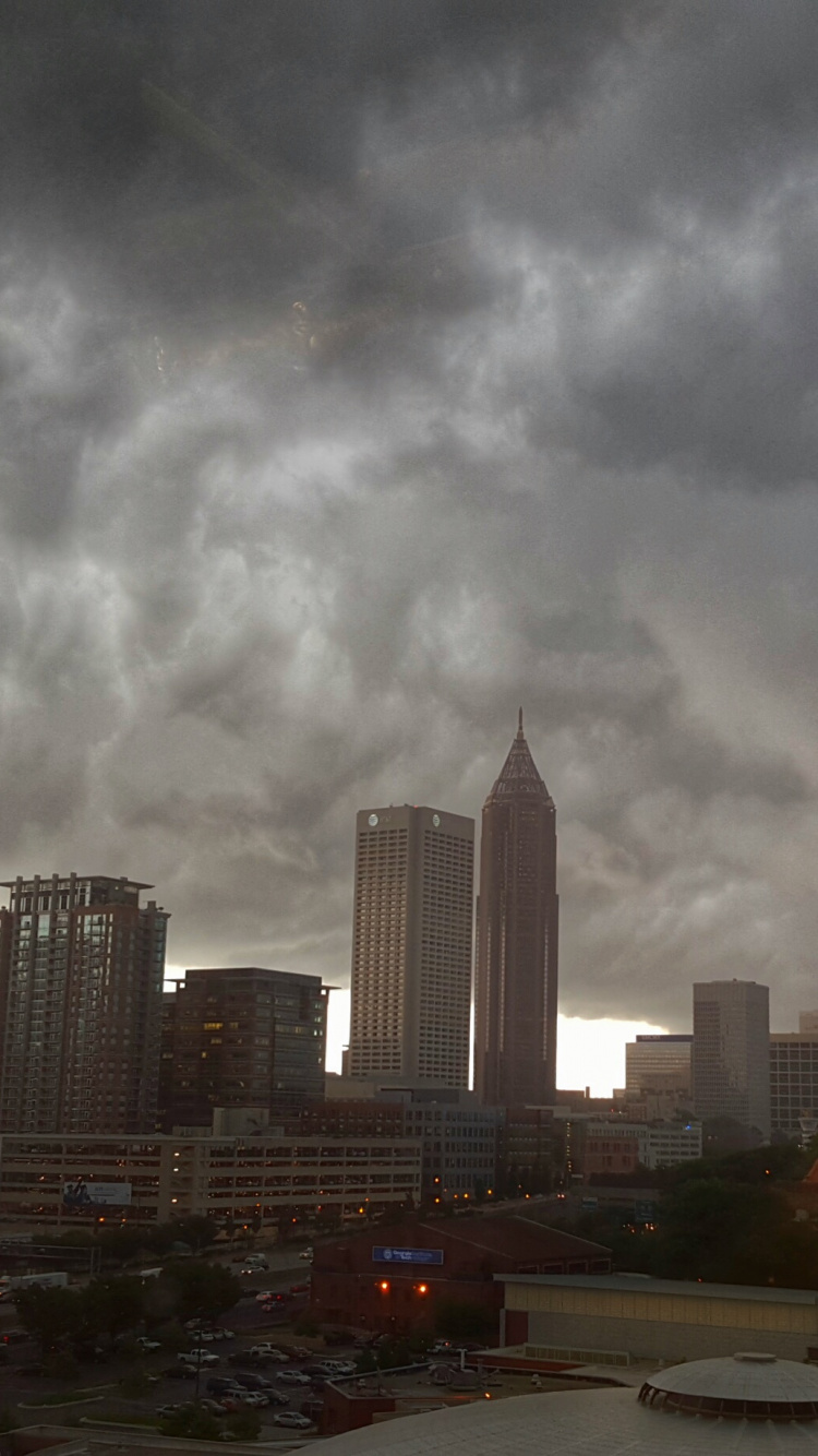 White and Black City Buildings Under Gray Clouds. Wallpaper in 750x1334 Resolution