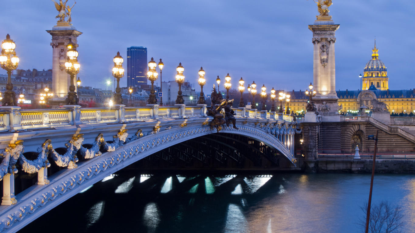Bridge Over Water Near City Buildings During Night Time. Wallpaper in 1366x768 Resolution