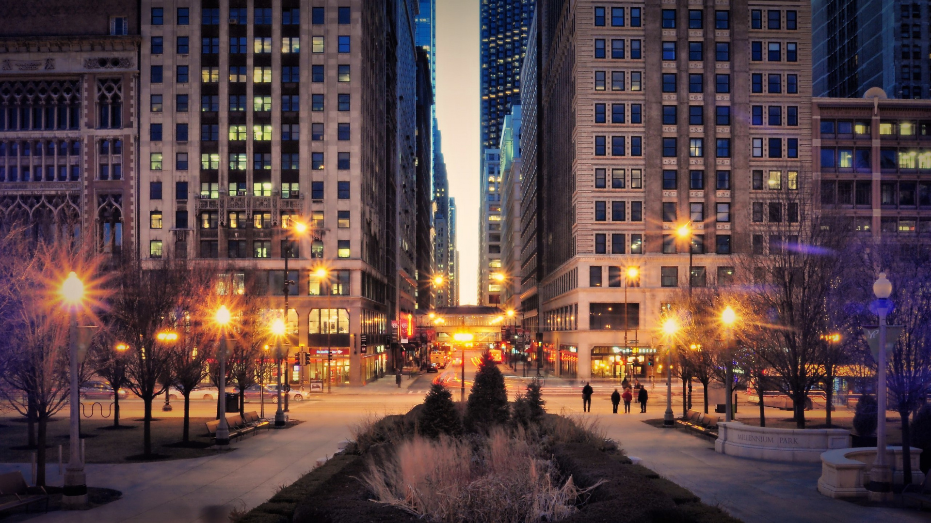 People Walking on Sidewalk Near High Rise Buildings During Night Time. Wallpaper in 1920x1080 Resolution