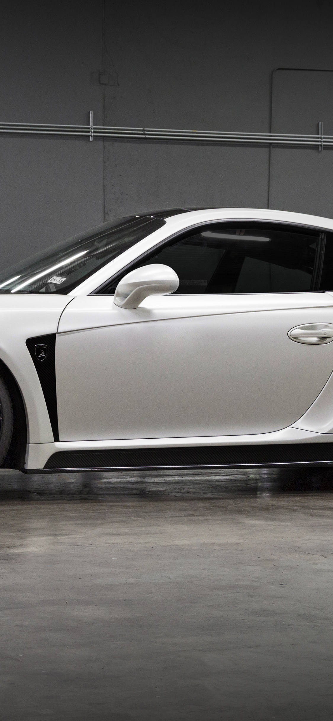 White Porsche 911 Parked in a Room. Wallpaper in 1125x2436 Resolution