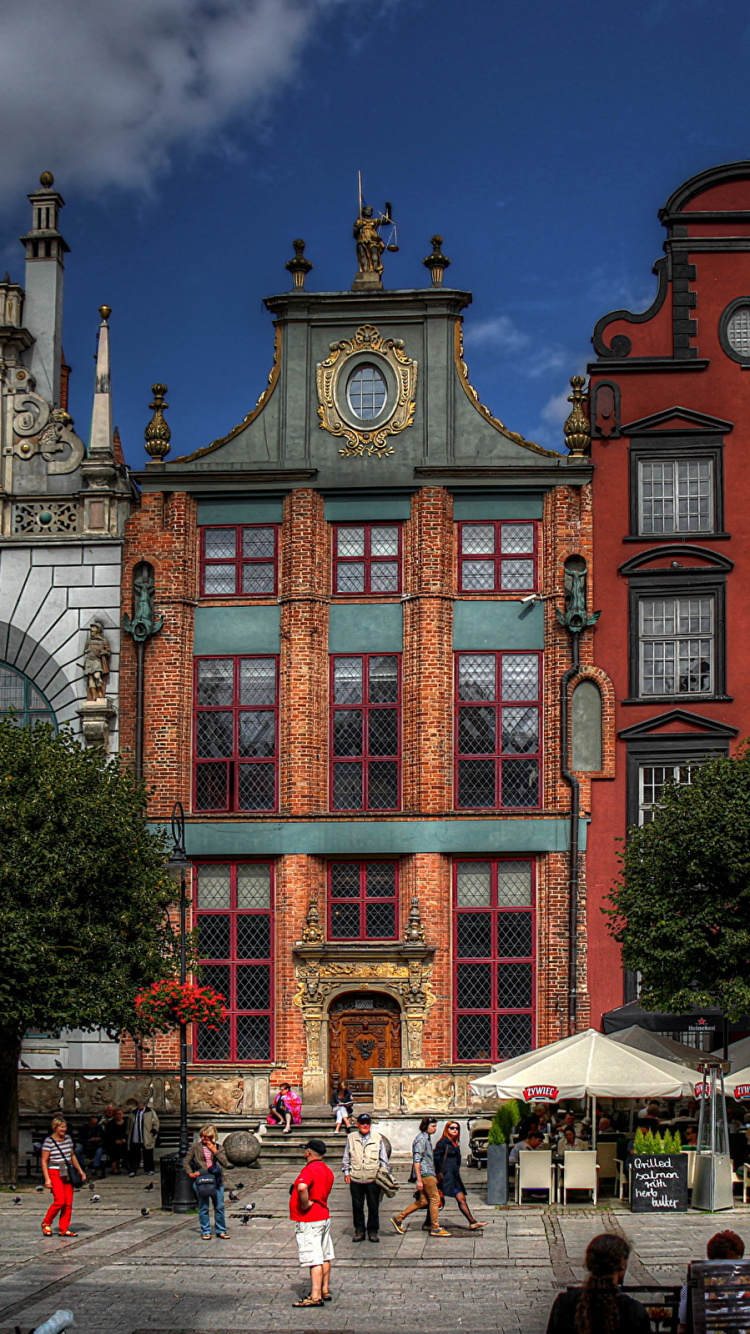 People Walking on Street Near Brown Concrete Building During Nighttime. Wallpaper in 750x1334 Resolution