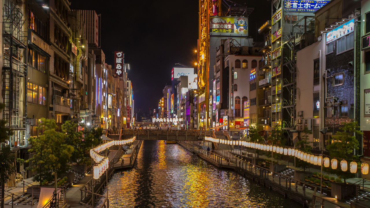 People Walking on Sidewalk Near Buildings During Night Time. Wallpaper in 1280x720 Resolution