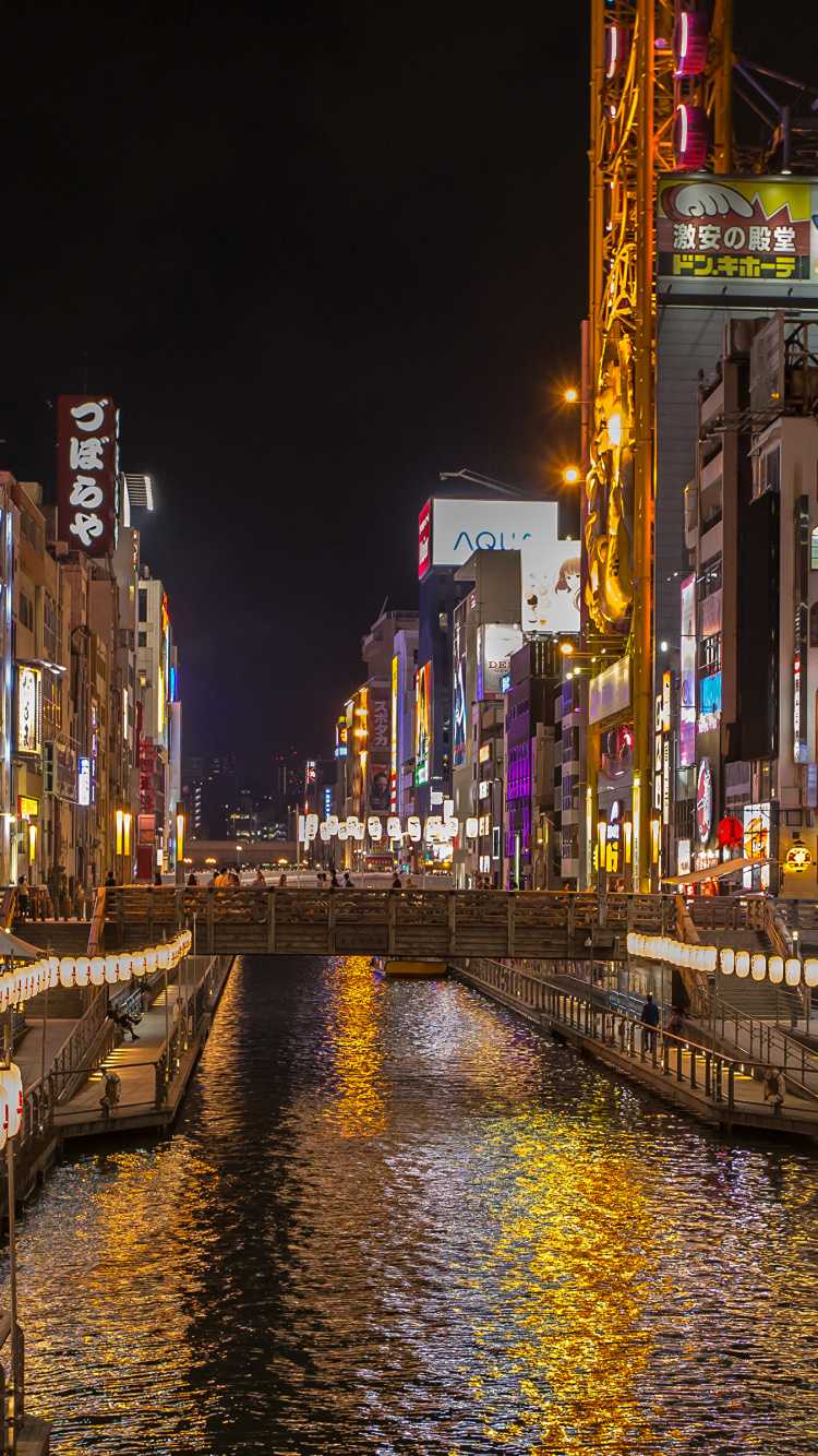 People Walking on Sidewalk Near Buildings During Night Time. Wallpaper in 750x1334 Resolution