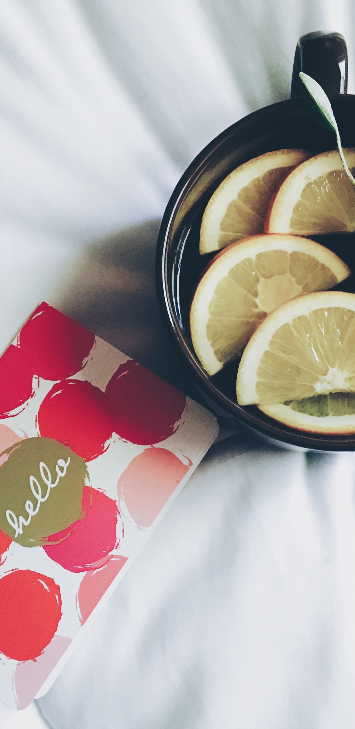 Sliced Lemon on Black Ceramic Bowl. Wallpaper in 1440x2960 Resolution