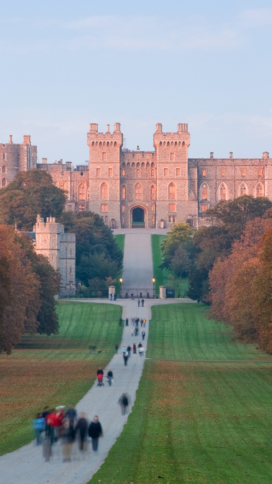 La Gente Caminando Sobre el Campo de Hierba Verde Cerca Del Edificio de Hormigón Marrón Durante el Día. Wallpaper in 1080x1920 Resolution