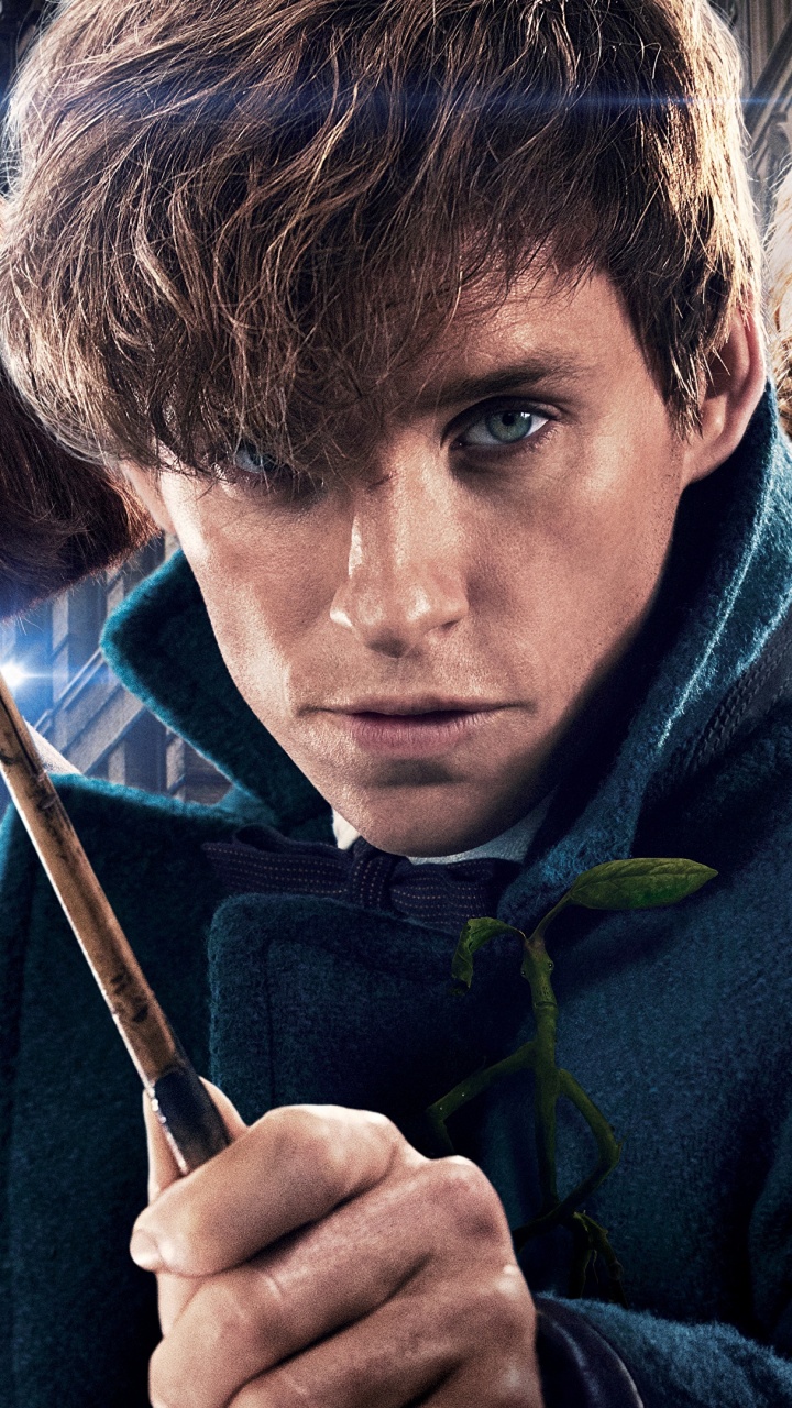 Man in Blue Hoodie Holding Black Stick. Wallpaper in 720x1280 Resolution