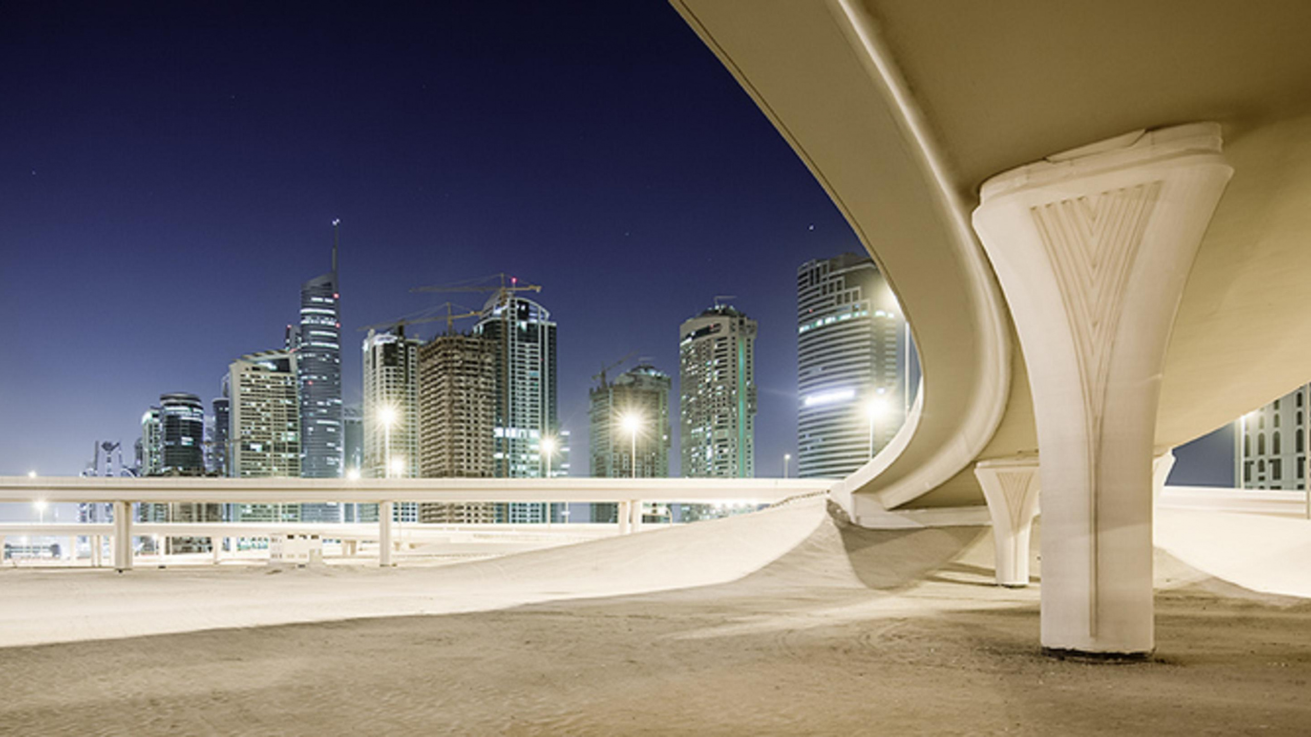 White Concrete Building During Nighttime. Wallpaper in 2560x1440 Resolution