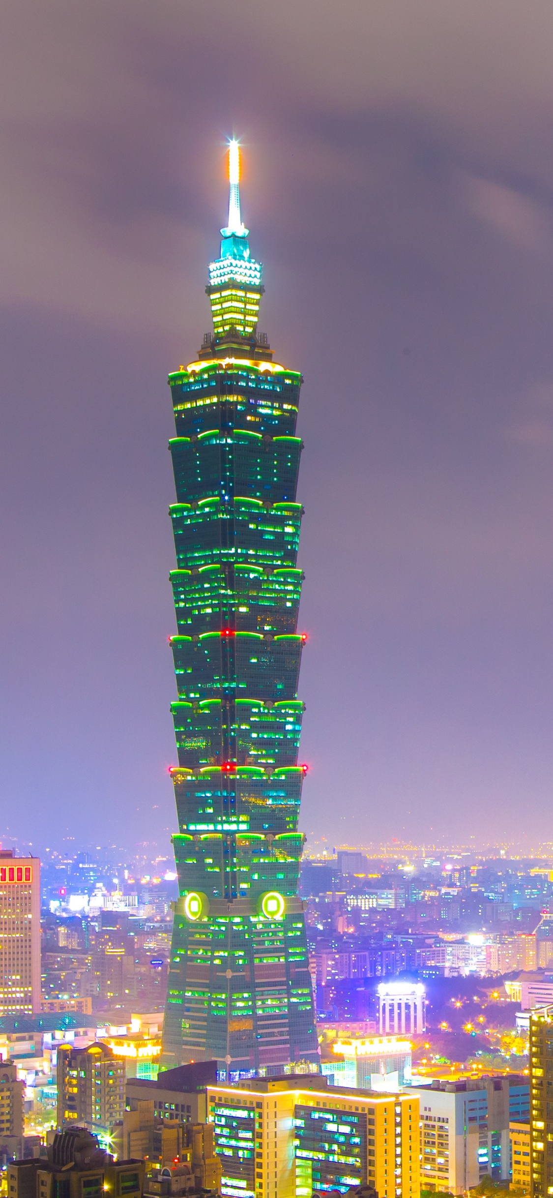 City Skyline During Night Time. Wallpaper in 1125x2436 Resolution