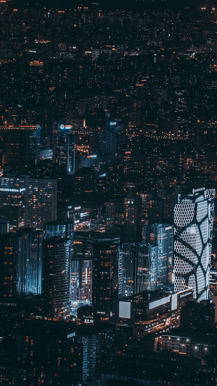 Luftaufnahme Von Stadtgebäuden Während Der Nacht. Wallpaper in 750x1334 Resolution