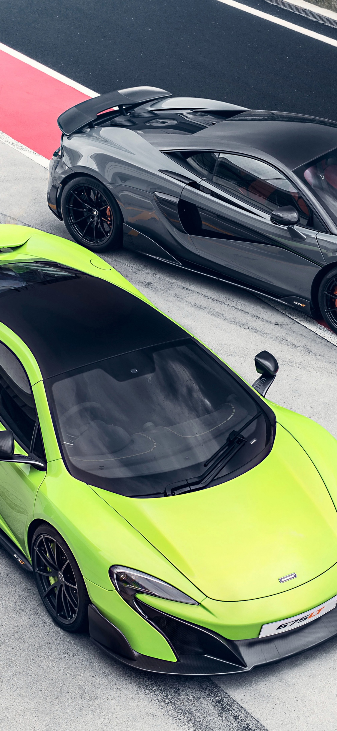 Green Ferrari 458 Italia on Road During Daytime. Wallpaper in 1125x2436 Resolution