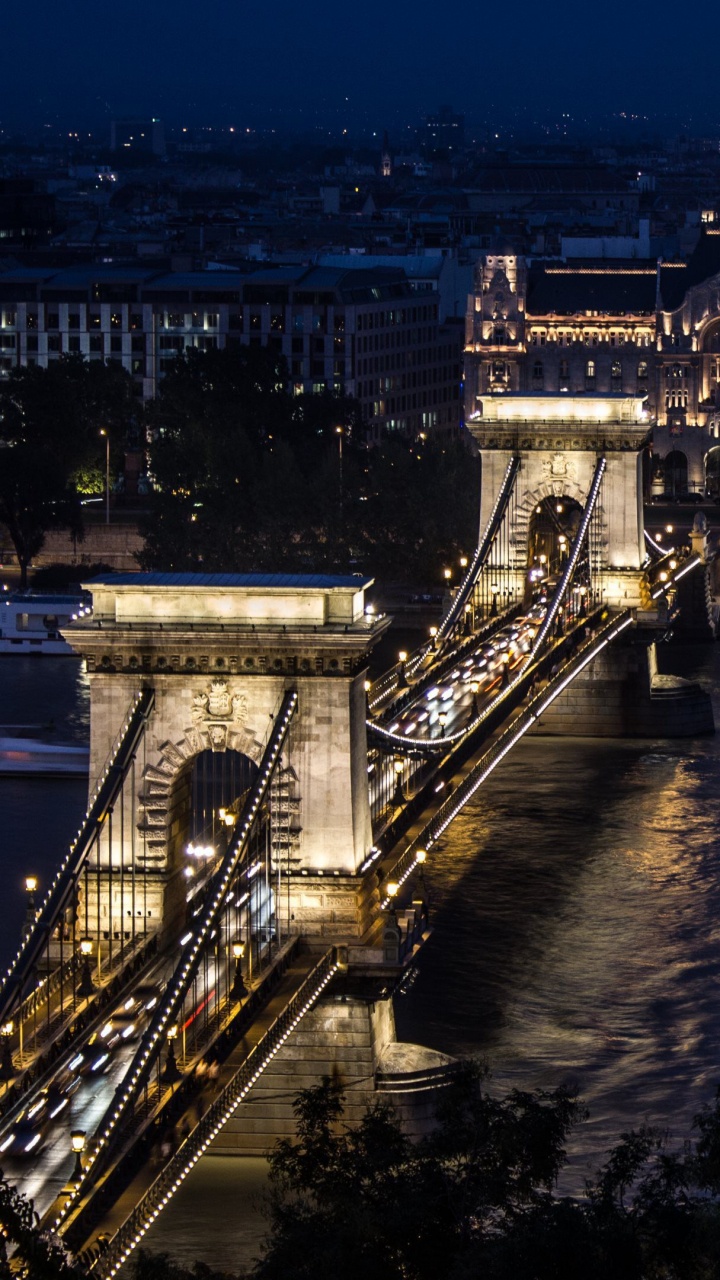 Lighted Bridge Over River During Night Time. Wallpaper in 720x1280 Resolution