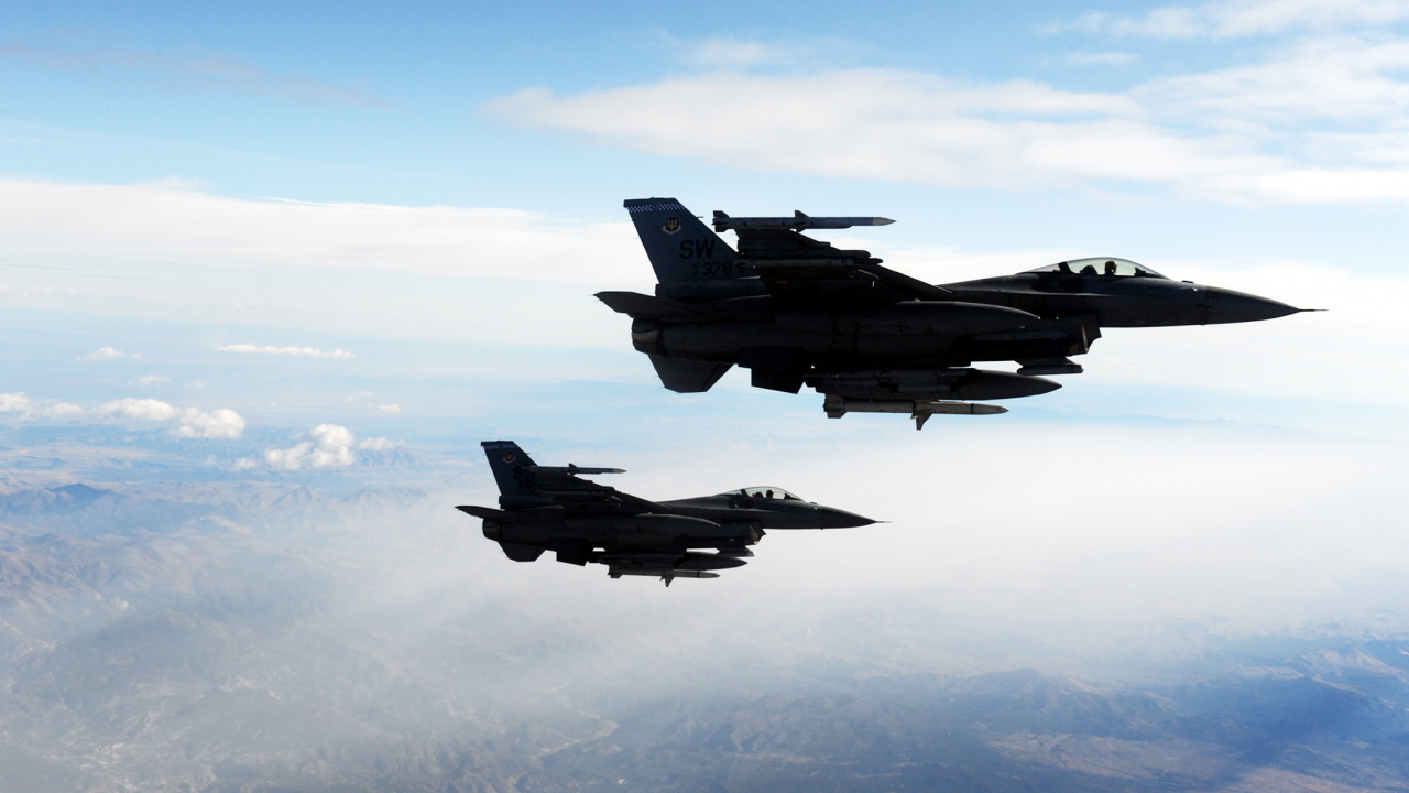 Fighter Jet Flying Over The Clouds During Daytime. Wallpaper in 1280x720 Resolution