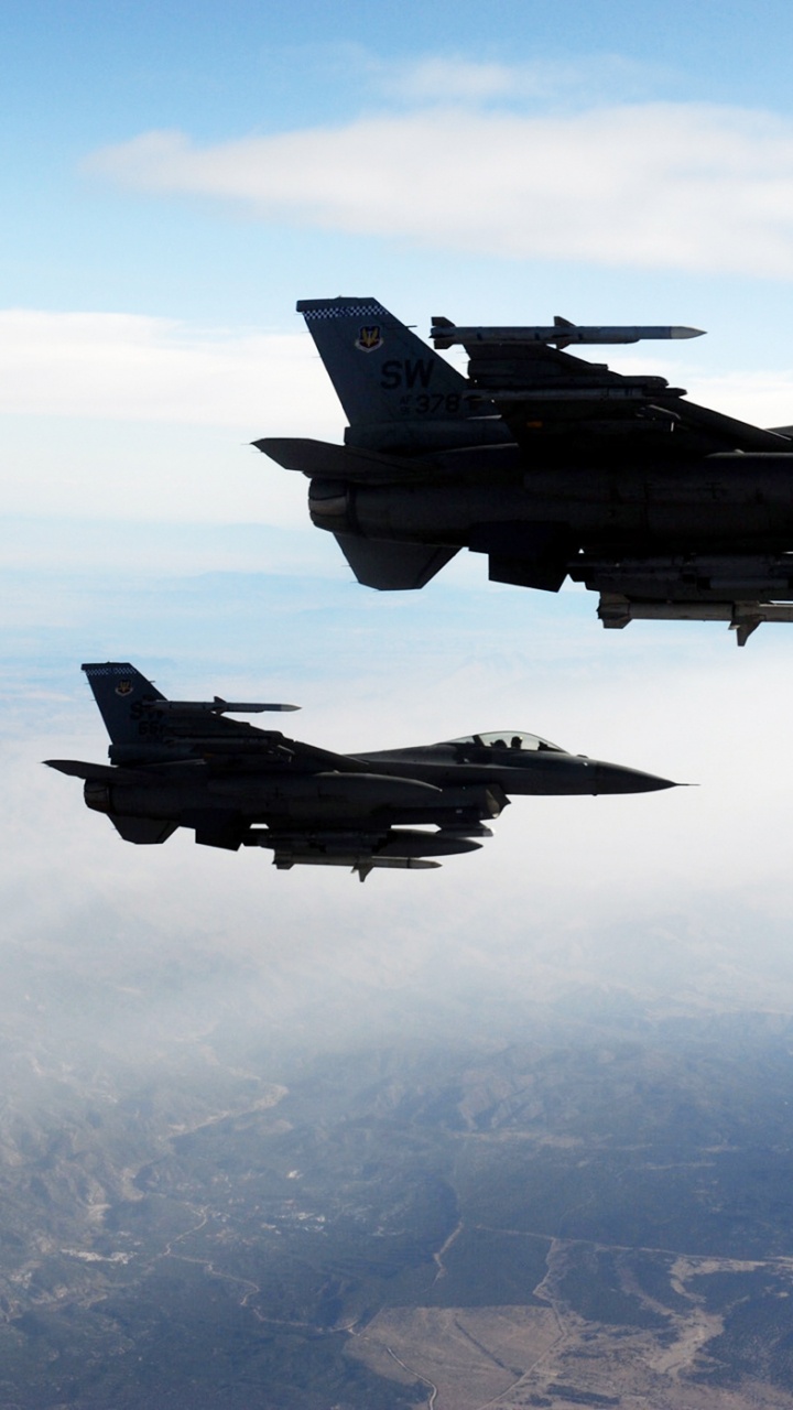 Fighter Jet Flying Over The Clouds During Daytime. Wallpaper in 720x1280 Resolution