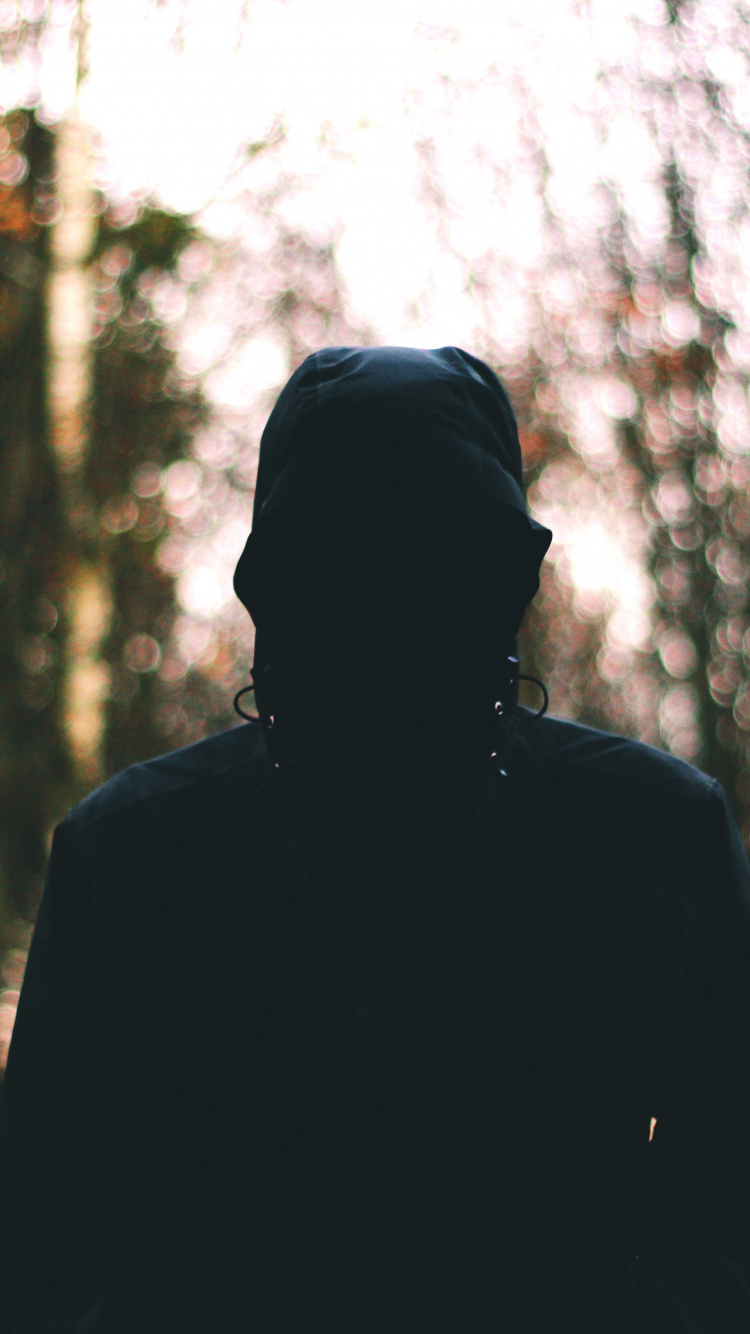 Man in Black Jacket Standing in Forest During Daytime. Wallpaper in 750x1334 Resolution