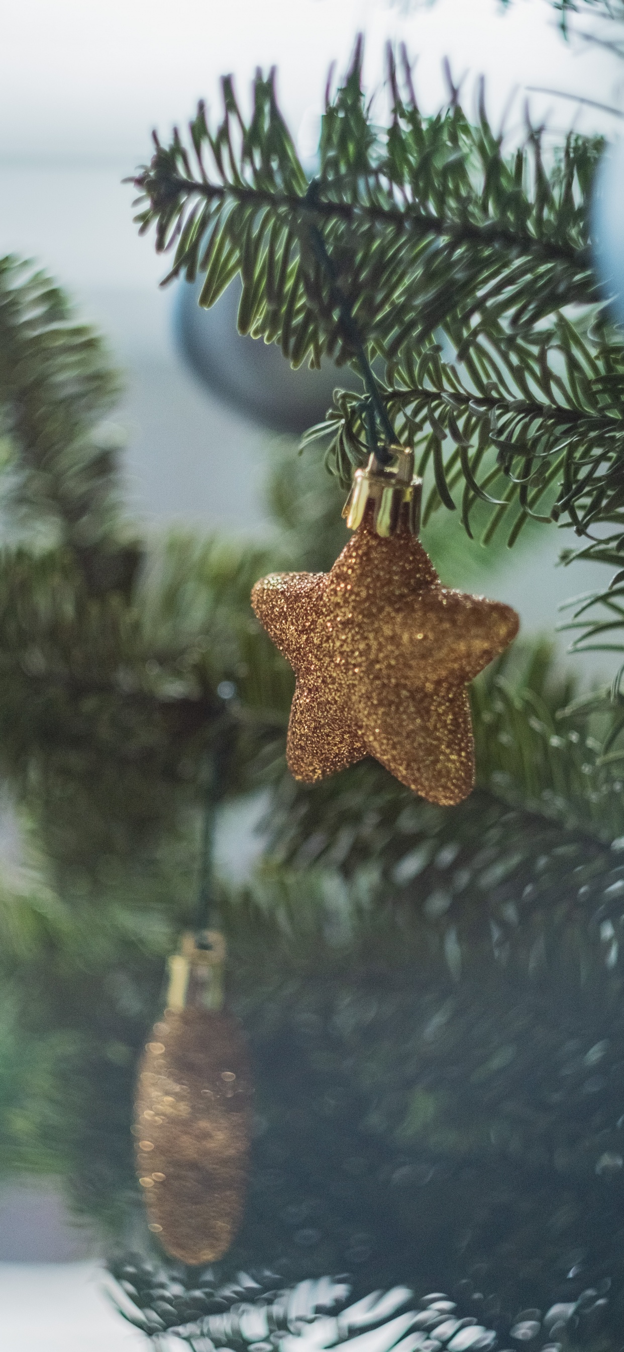 Gold Angel Ornament on Green Pine Tree. Wallpaper in 1242x2688 Resolution