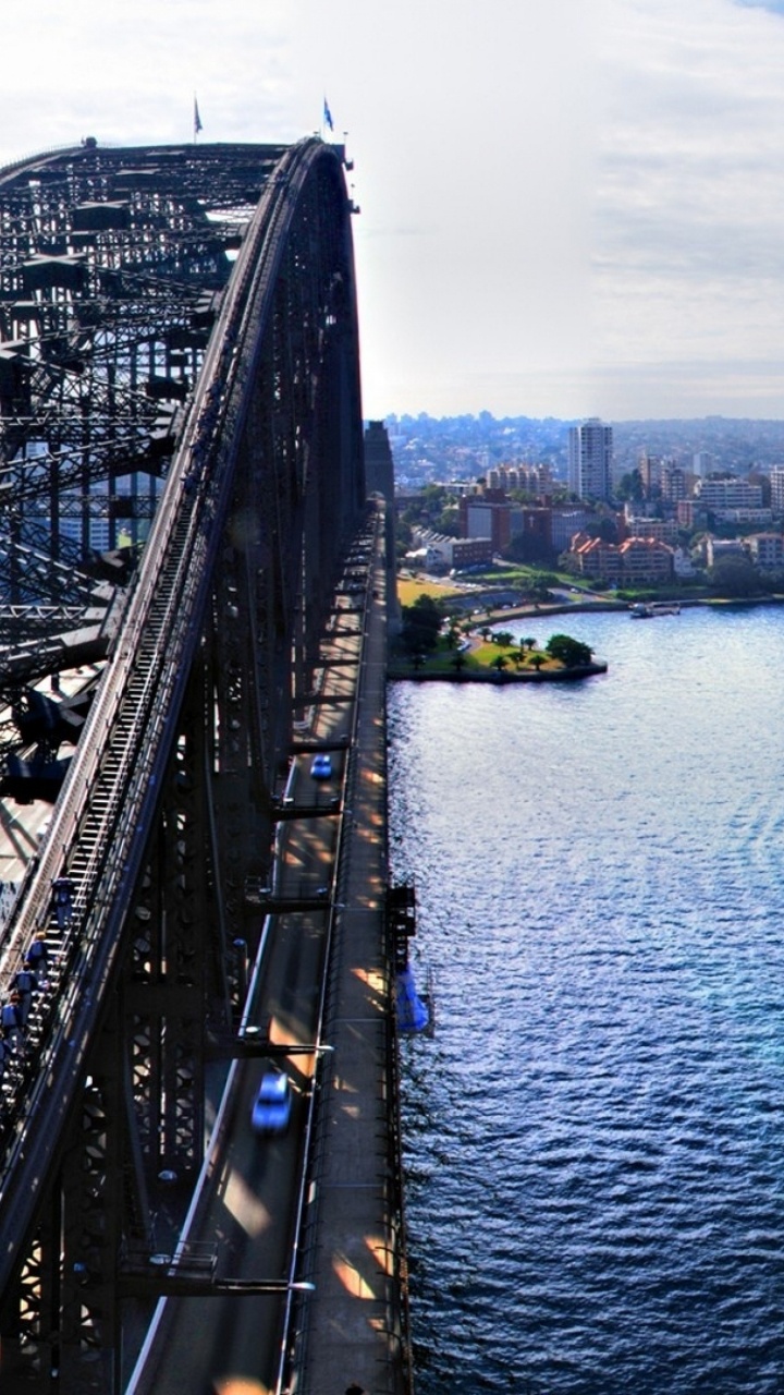 Gray Steel Bridge Over Body of Water During Daytime. Wallpaper in 720x1280 Resolution