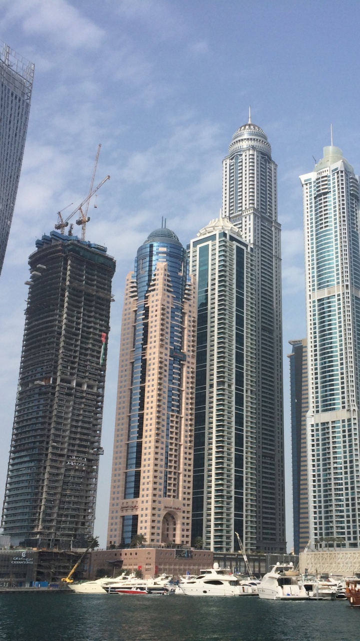 White and Blue High Rise Buildings Near Body of Water During Daytime. Wallpaper in 720x1280 Resolution