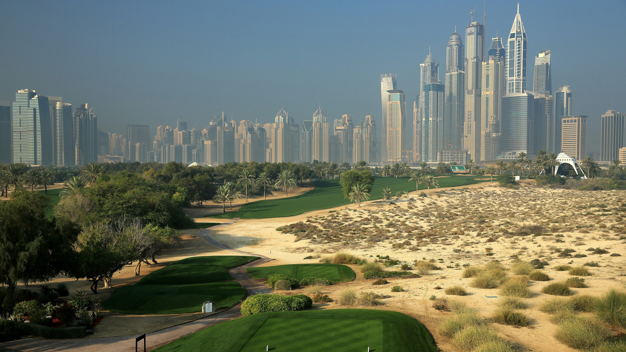 Champ D'herbe Verte Près Des Bâtiments de la Ville Pendant la Journée. Wallpaper in 2560x1440 Resolution