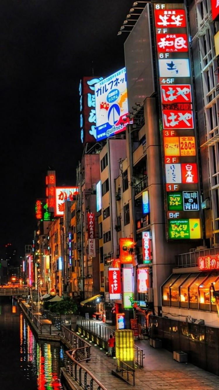 People Walking on Sidewalk During Night Time. Wallpaper in 750x1334 Resolution