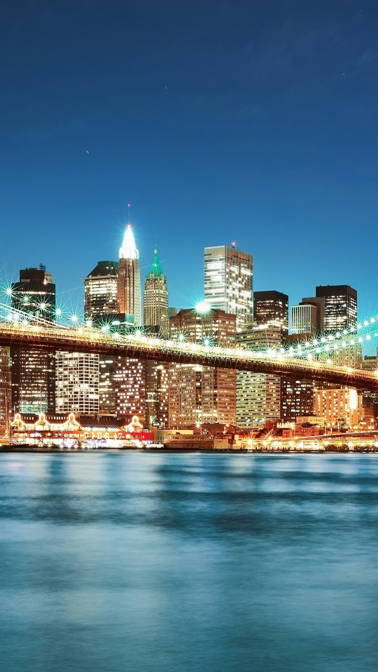 Lighted Bridge Over Water During Night Time. Wallpaper in 750x1334 Resolution