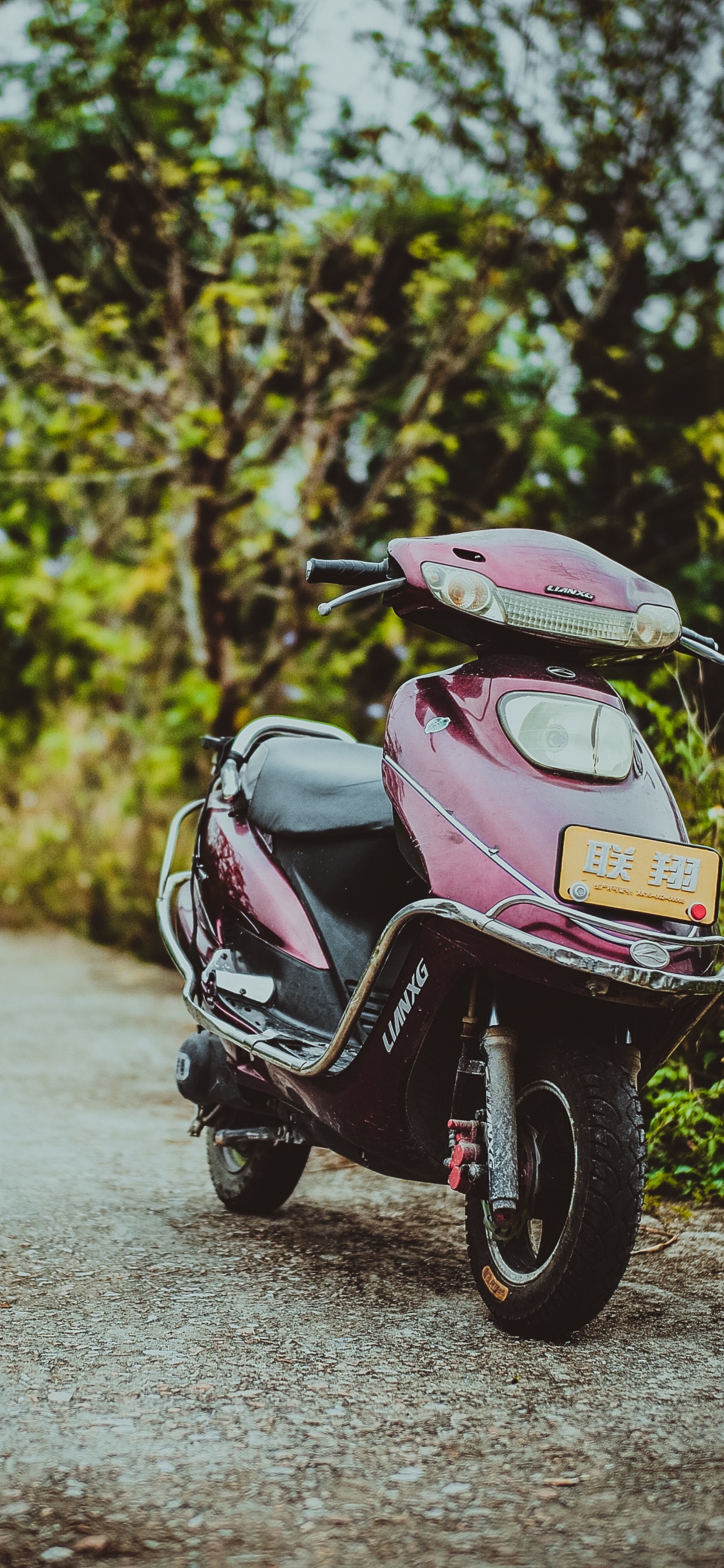 Pink and Black Motor Scooter Parked on Gray Concrete Road During Daytime. Wallpaper in 1242x2688 Resolution