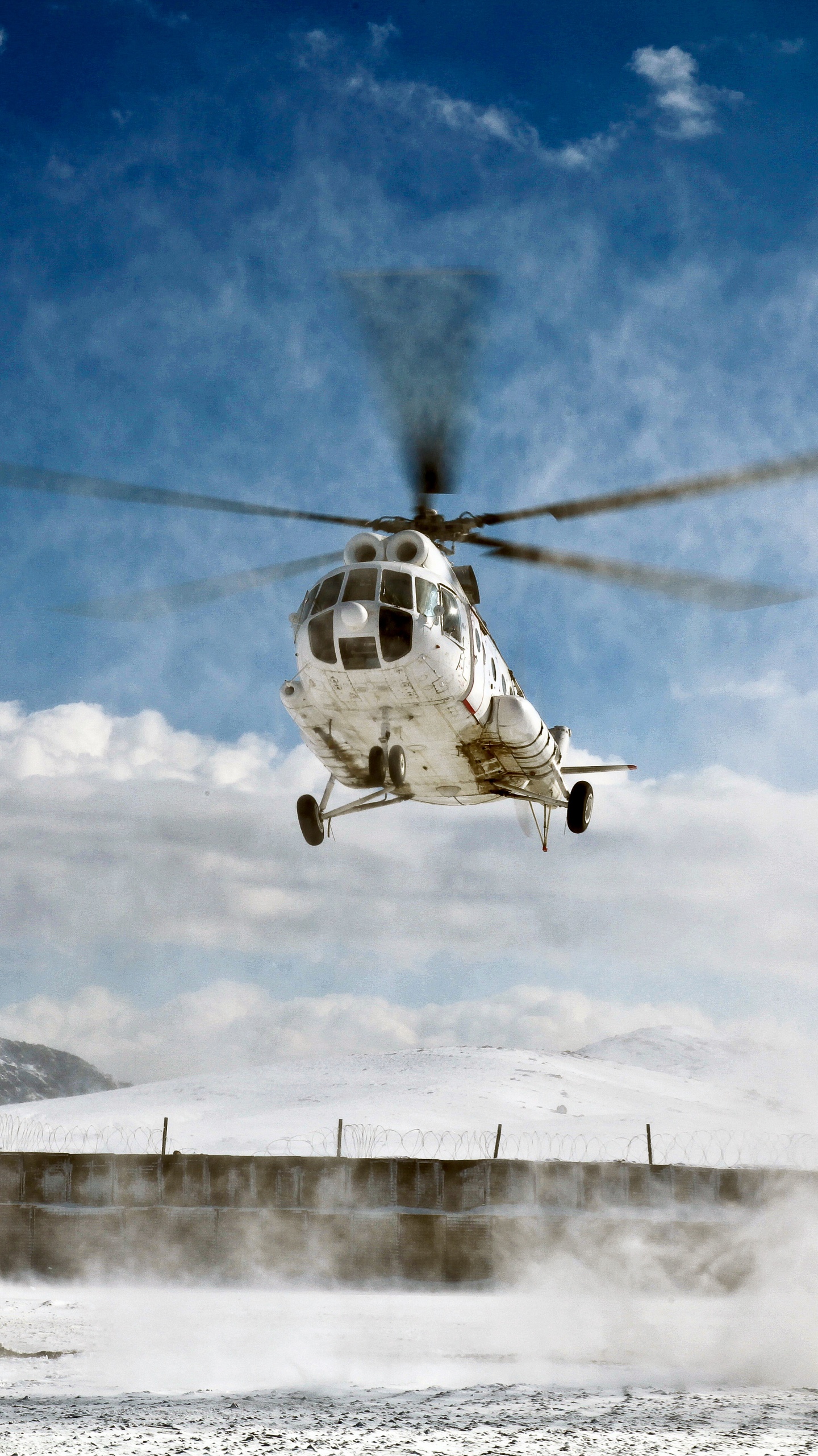 White and Black Helicopter Flying Over Snow Covered Mountain During Daytime. Wallpaper in 1440x2560 Resolution
