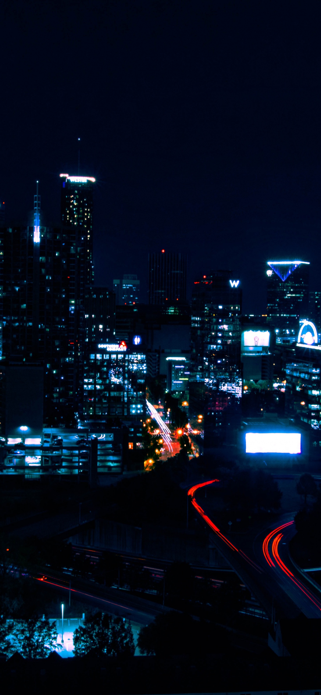 City With High Rise Buildings During Night Time. Wallpaper in 1242x2688 Resolution