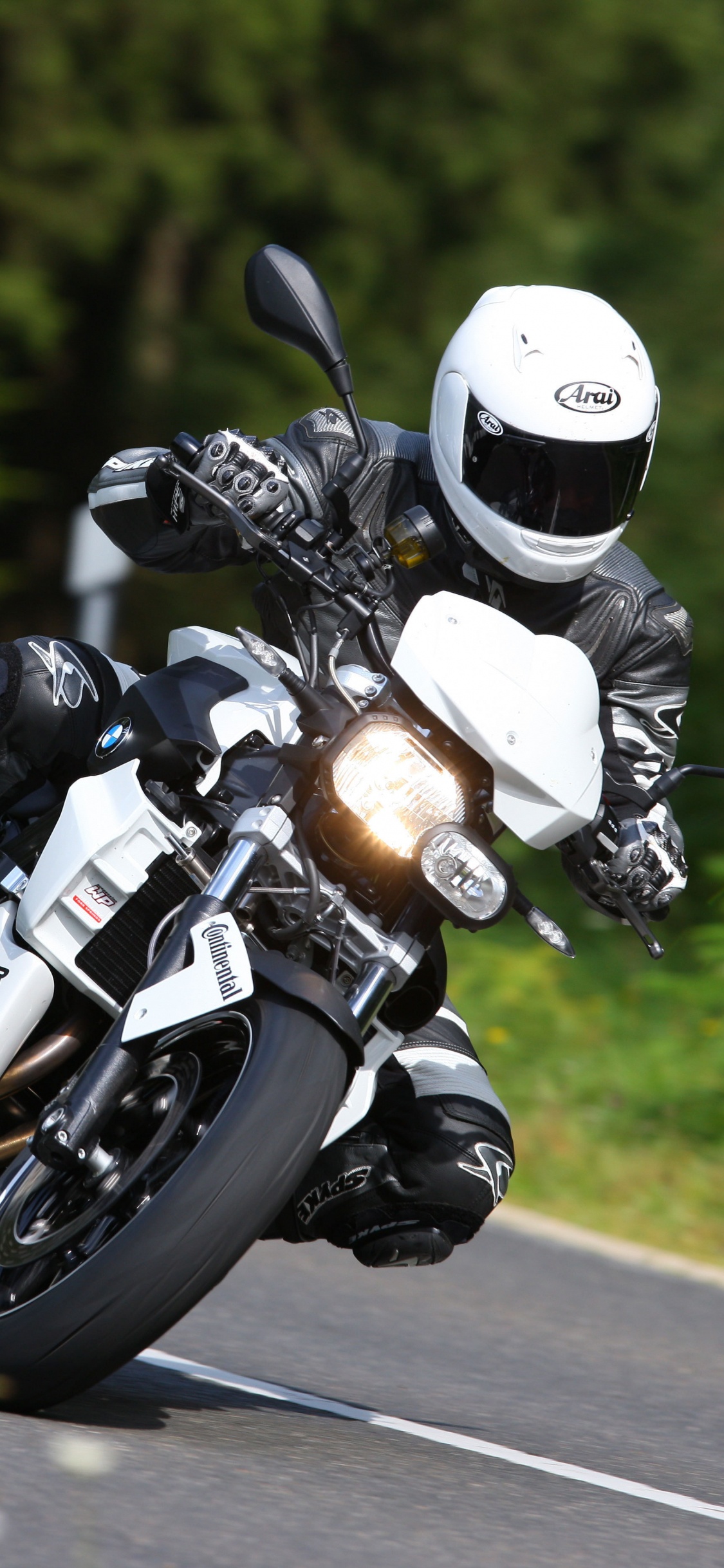 Man in Black Helmet Riding Motorcycle on Road During Daytime. Wallpaper in 1125x2436 Resolution