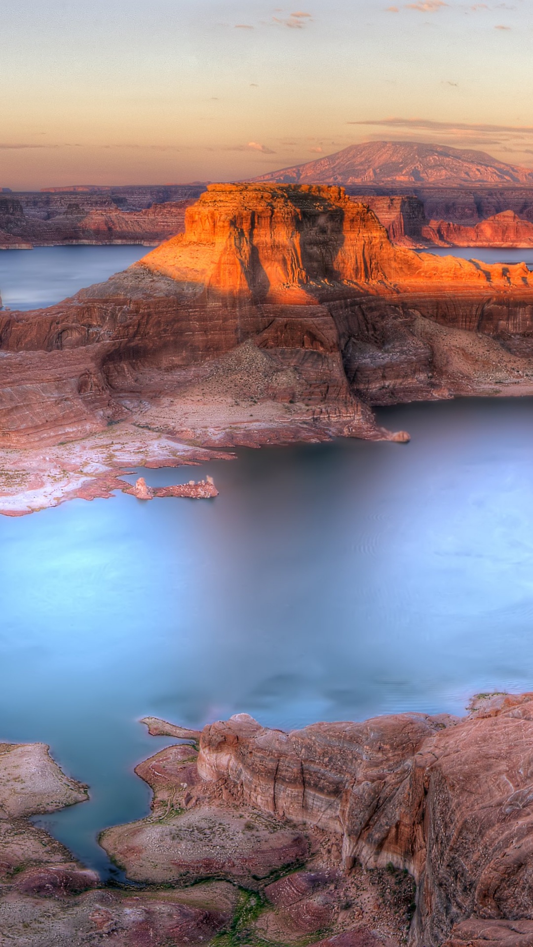 Brown Rocky Mountain Beside Body of Water During Daytime. Wallpaper in 1080x1920 Resolution