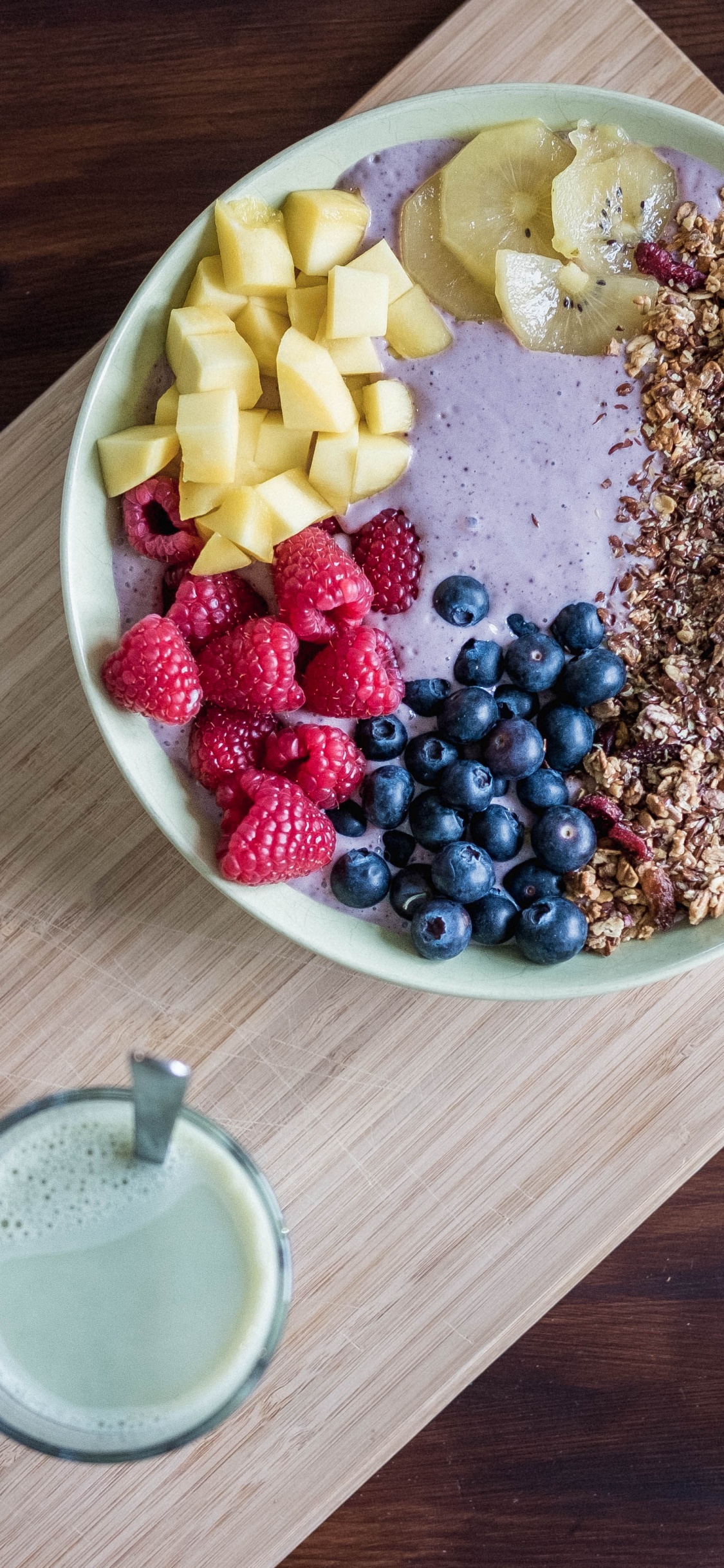 Stainless Steel Spoon Beside White Ceramic Bowl With Brown and Black Beans. Wallpaper in 1125x2436 Resolution