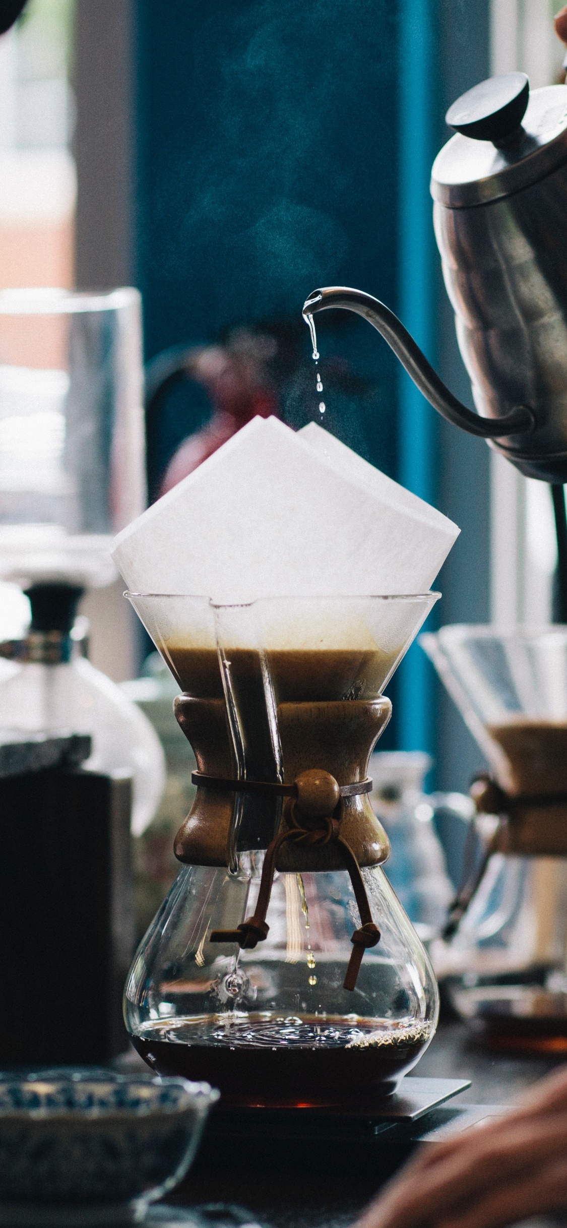 Person Pouring Water on Clear Glass Cup. Wallpaper in 1125x2436 Resolution