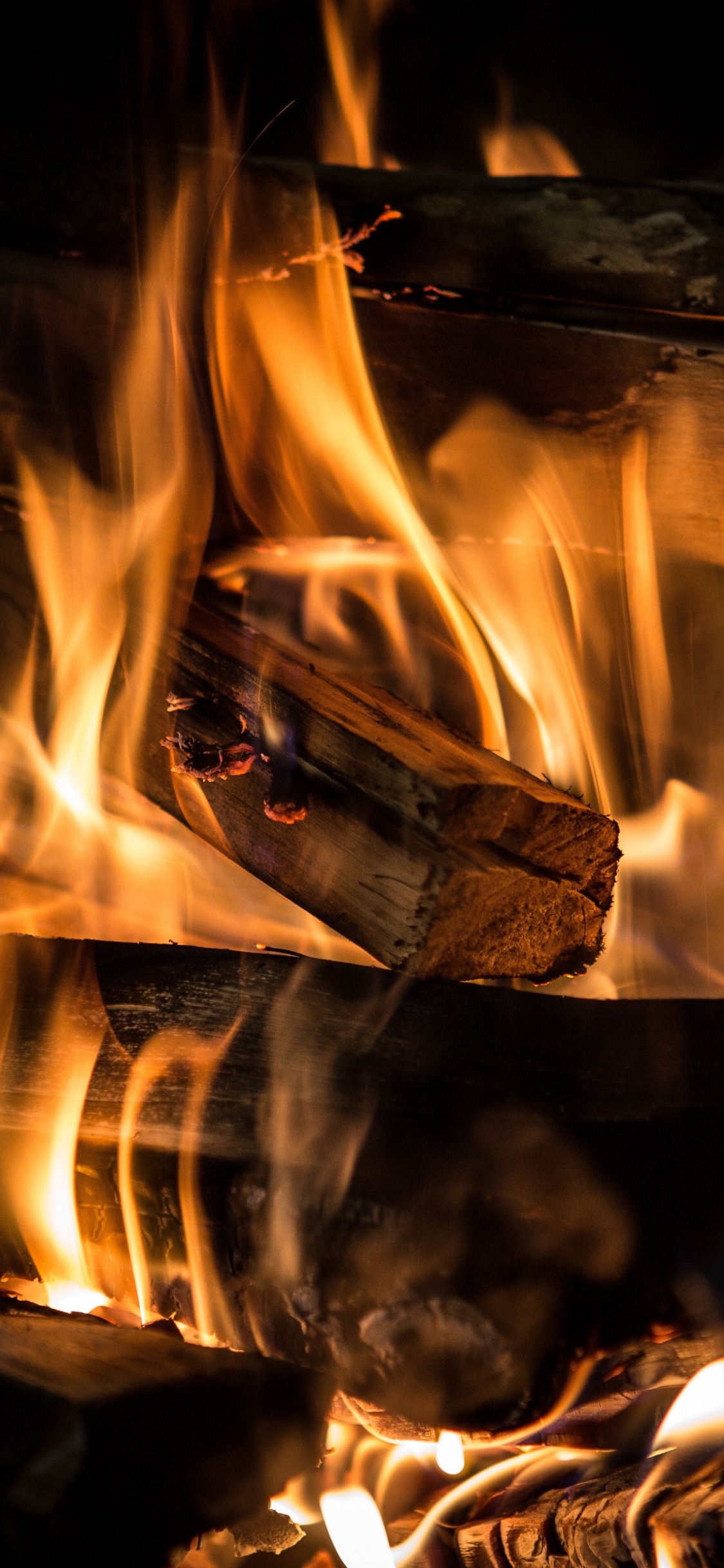 Burning Wood on Fire Pit. Wallpaper in 1125x2436 Resolution