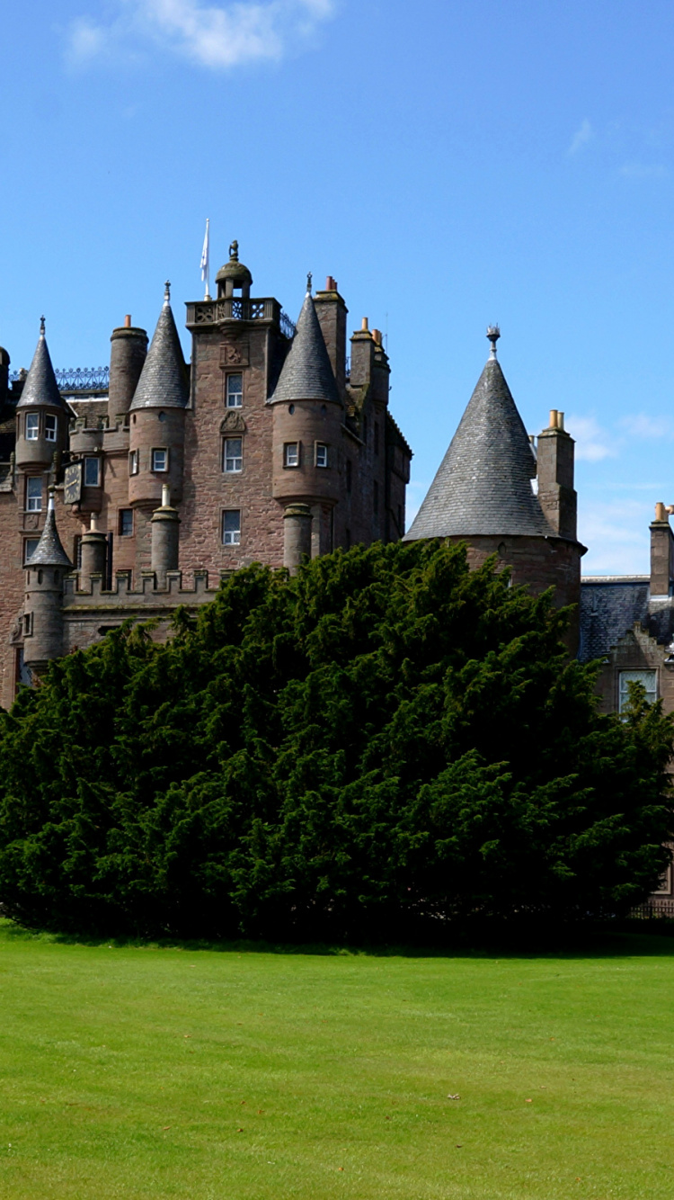 Brown Concrete Castle Surrounded by Green Grass Field Under Blue Sky During Daytime. Wallpaper in 750x1334 Resolution