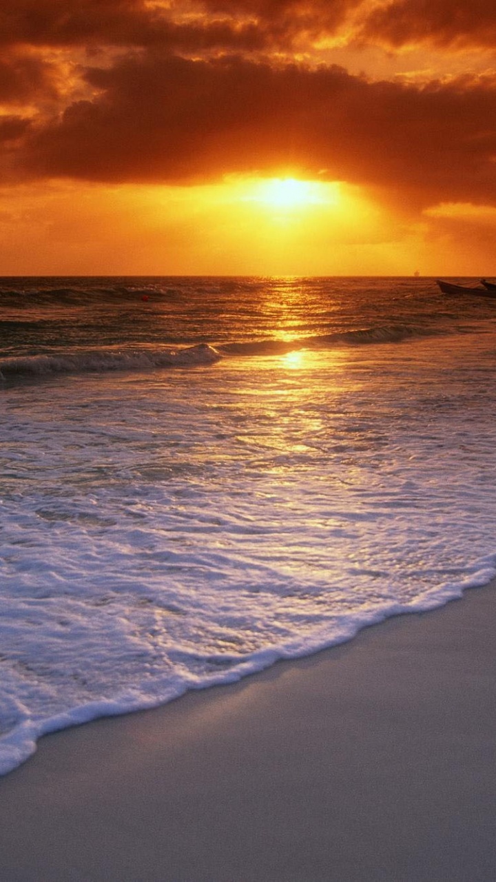 Sea Waves Crashing on Shore During Sunset. Wallpaper in 720x1280 Resolution