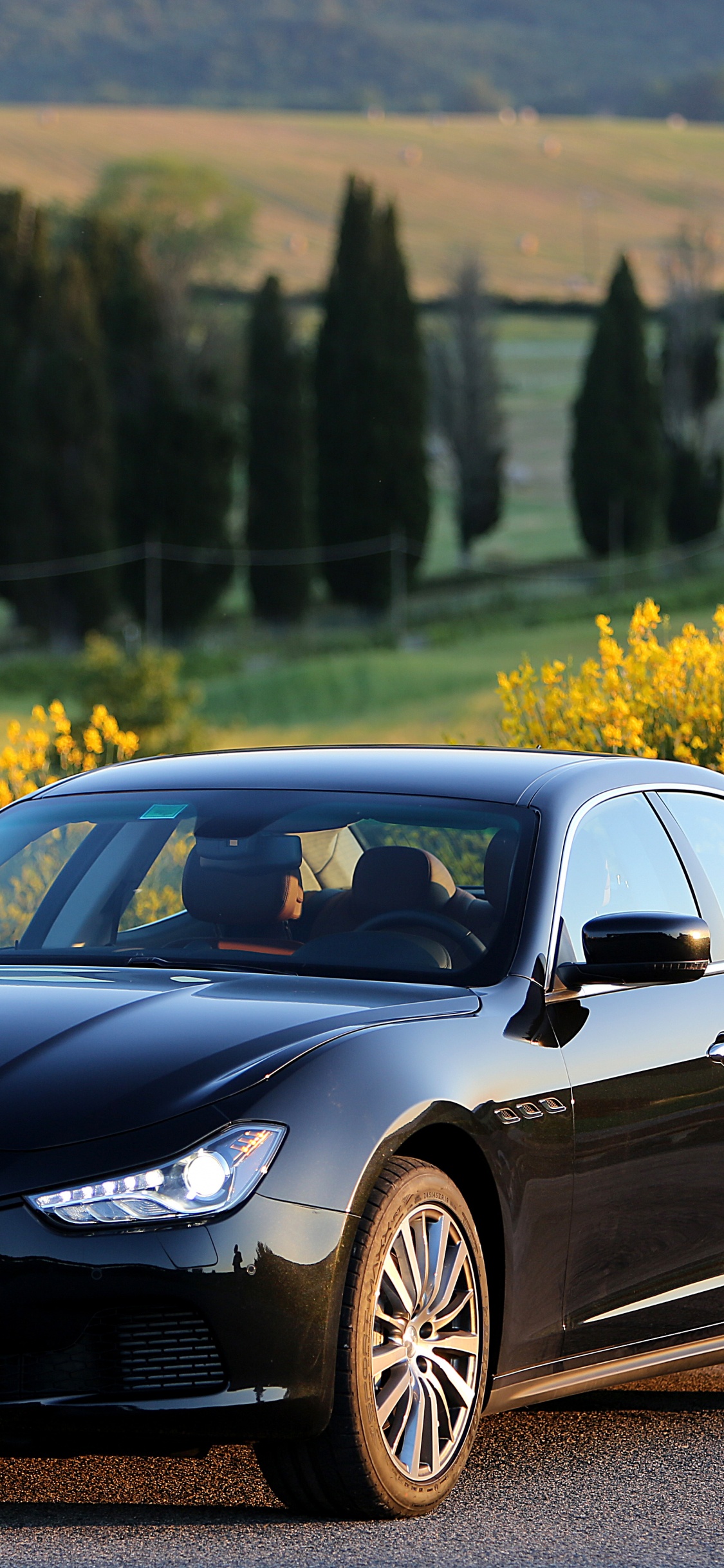 Black Porsche 911 Parked on Road During Daytime. Wallpaper in 1125x2436 Resolution
