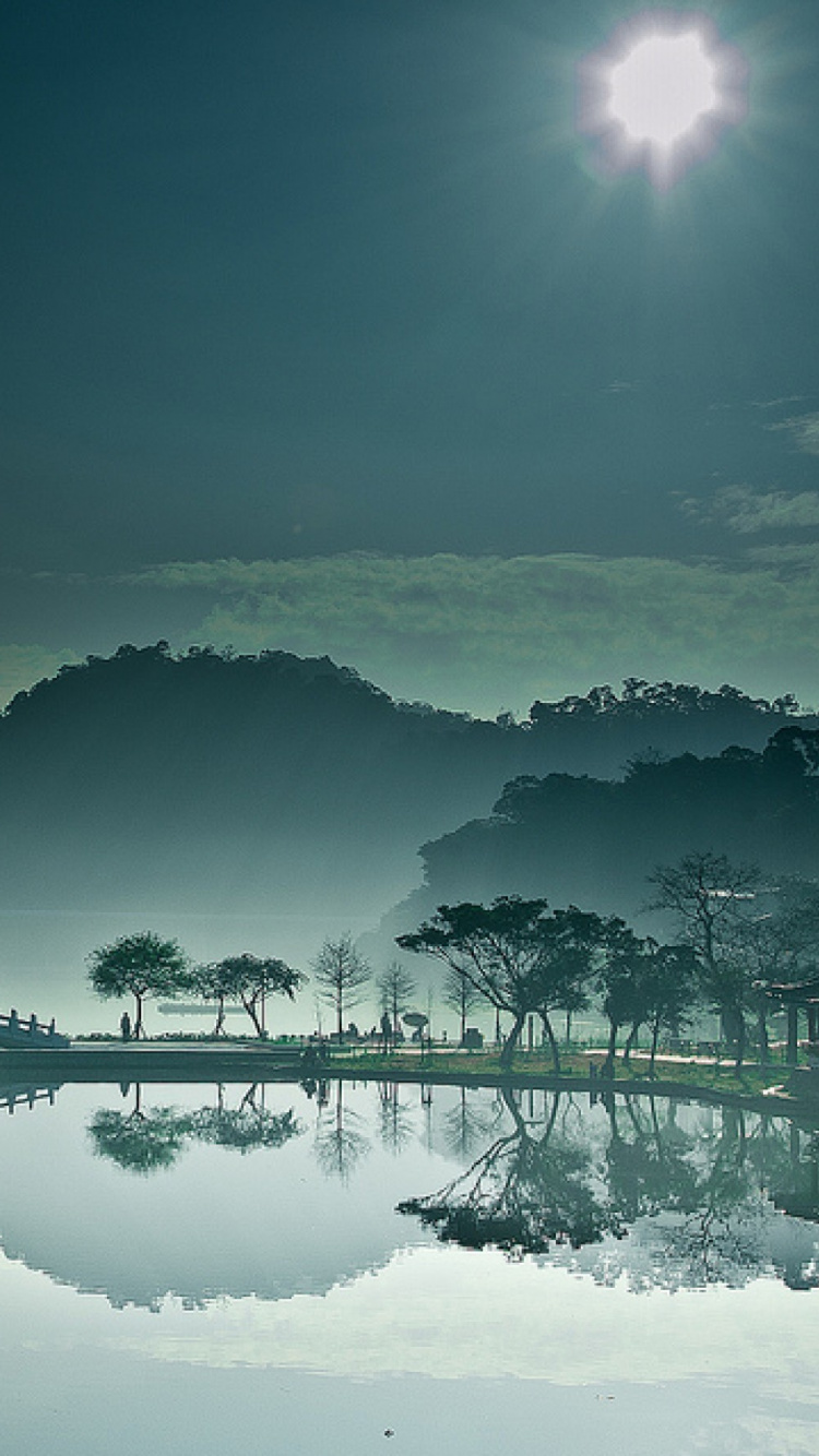 Body of Water Near Trees During Night Time. Wallpaper in 750x1334 Resolution
