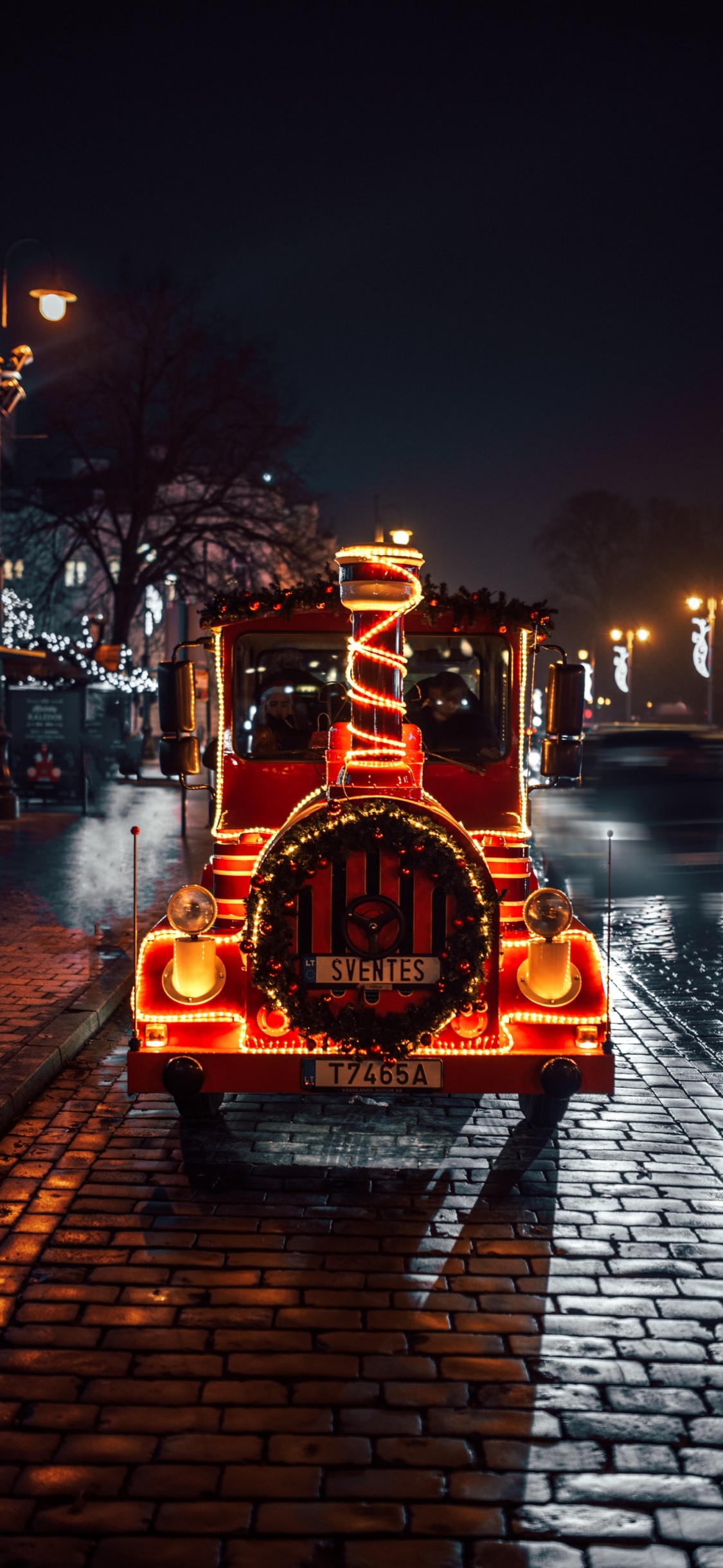 Red and Black Vehicle on Road During Night Time. Wallpaper in 1125x2436 Resolution
