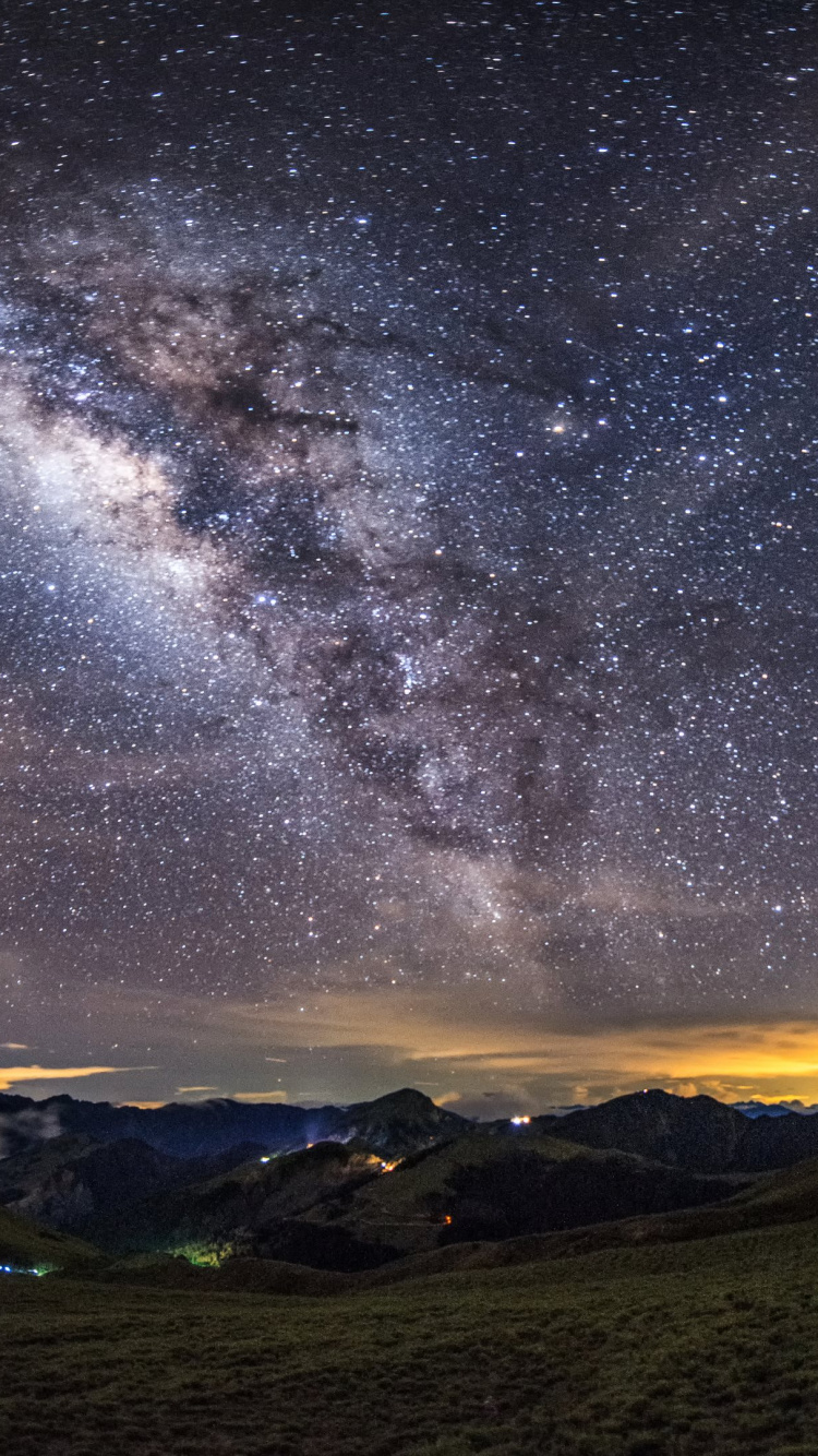 Green Grass Field Under Starry Night. Wallpaper in 750x1334 Resolution