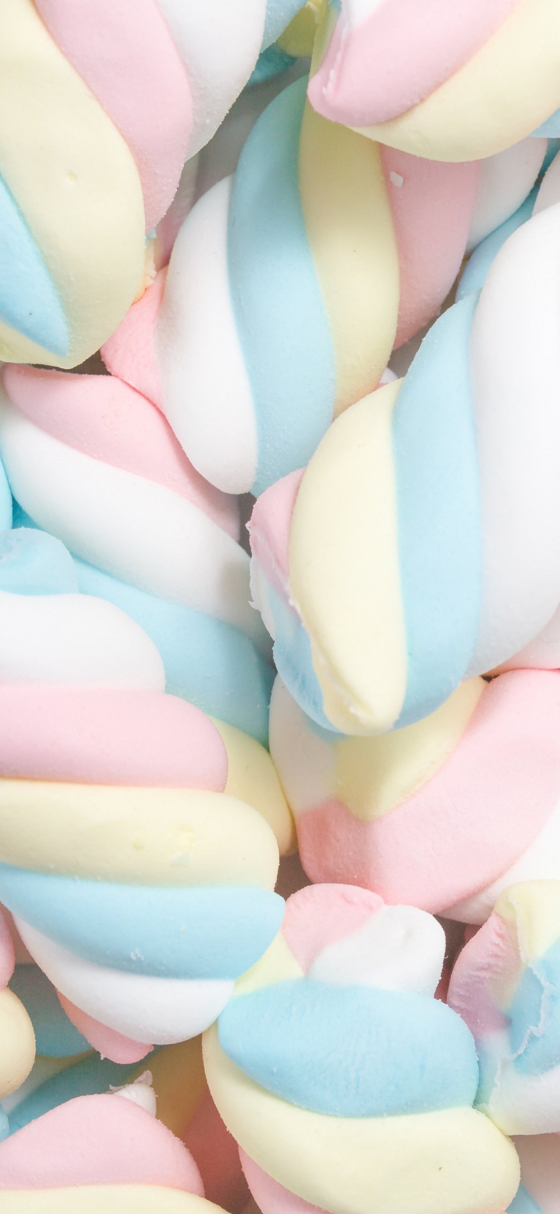 Pink Yellow and White Heart Shaped Candies. Wallpaper in 1125x2436 Resolution